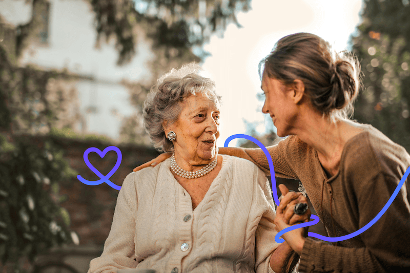 Bild einer älteren Dame sie eine junge Dame freudig anschaut und mit ihr im Gespräch ist