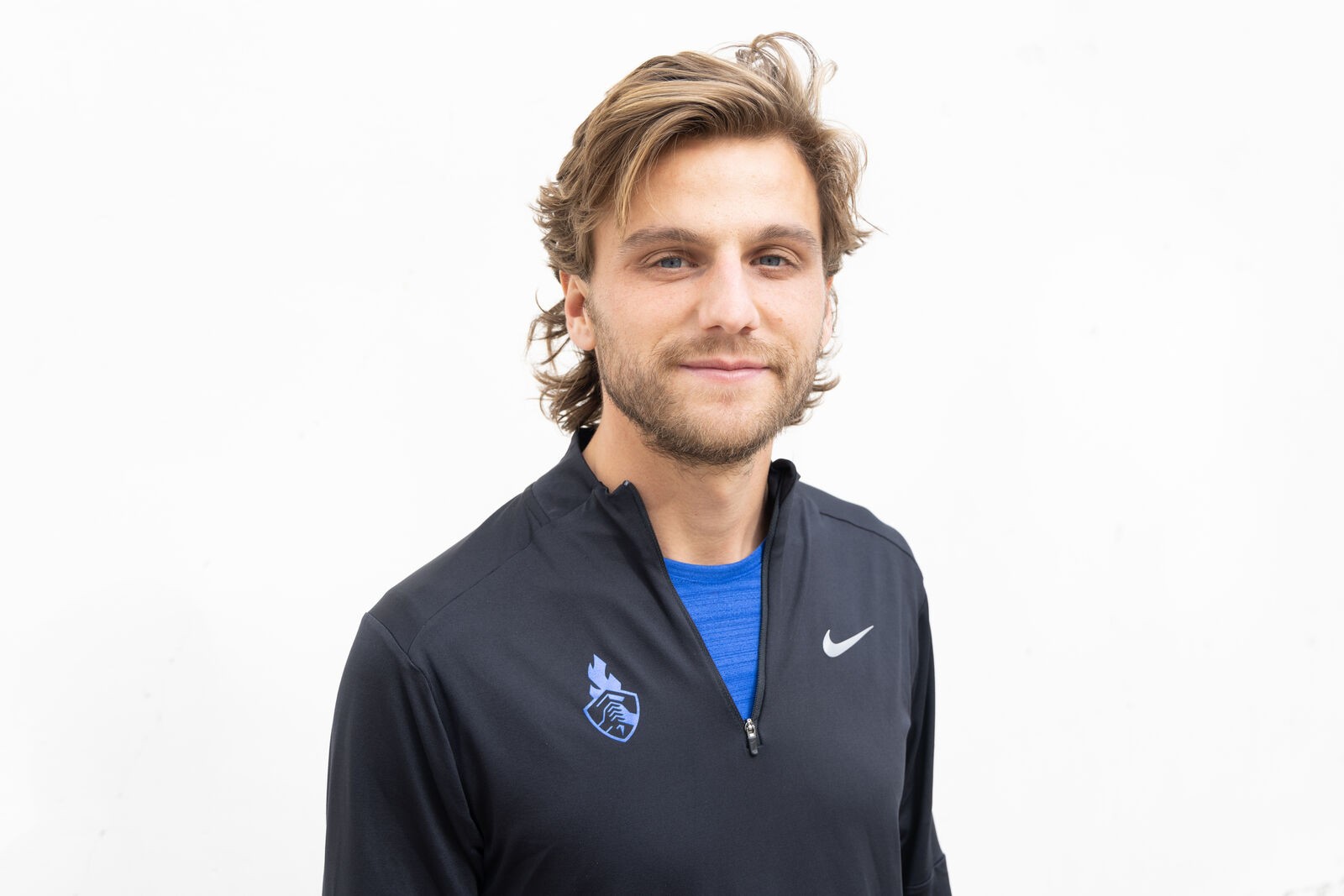 Nike shoot, a close portrait in a black quarter-zip