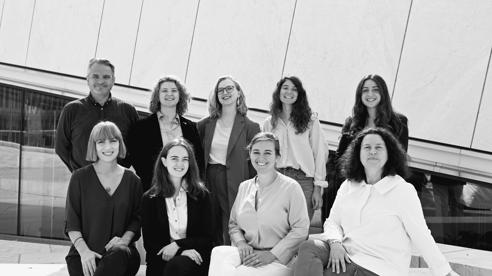 Three people relaxing in front of mountains