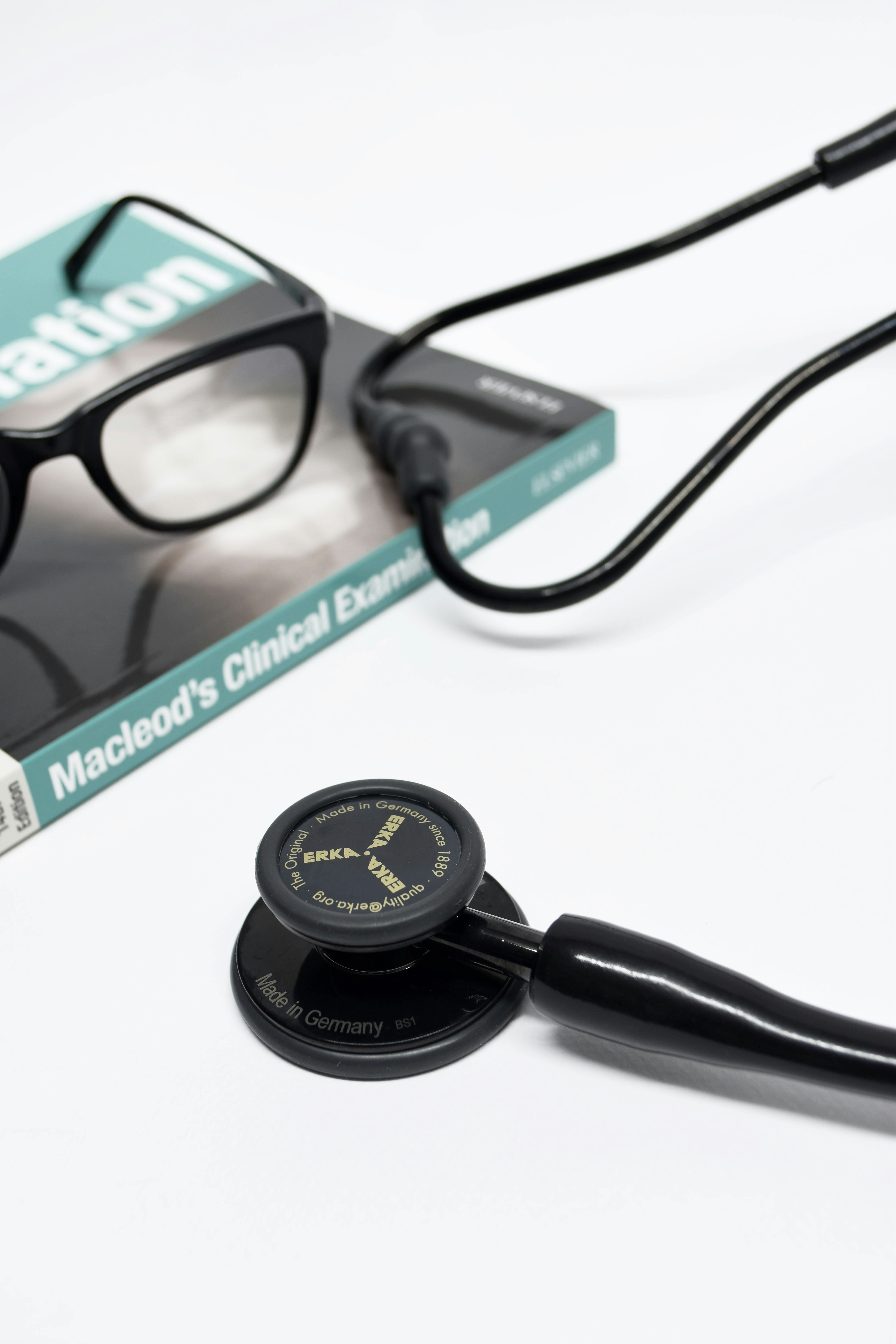 black stethoscope near black framed eyeglasses