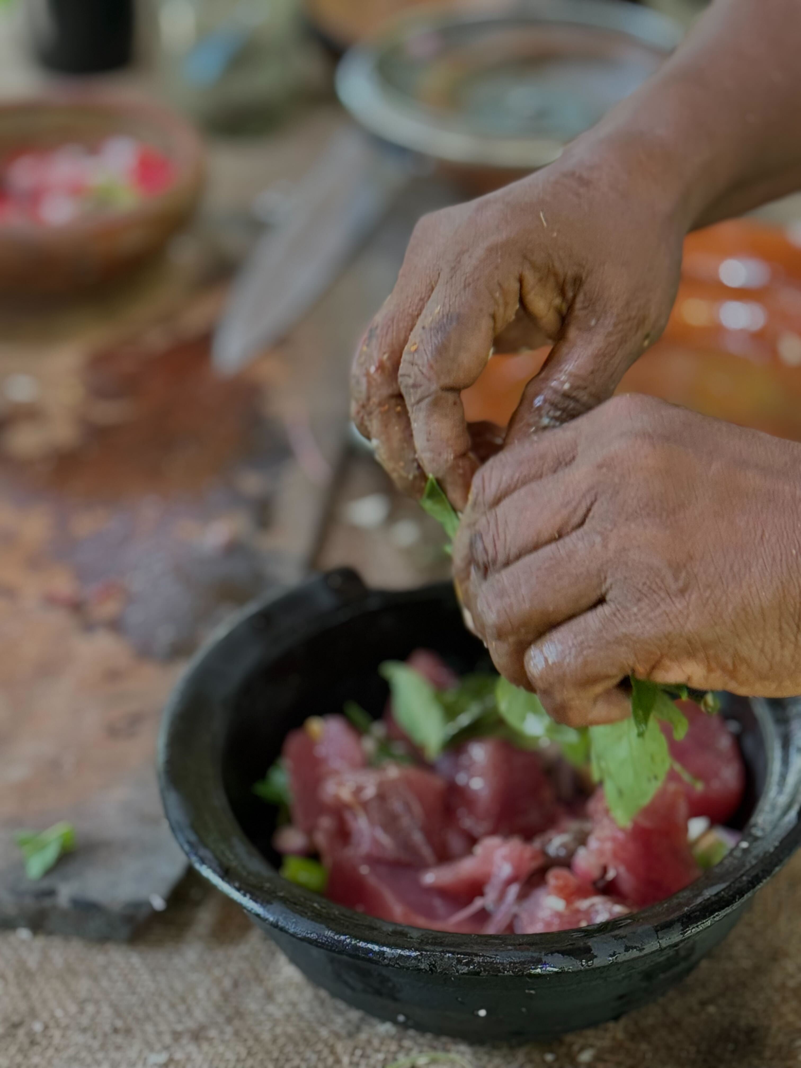 a group of women standing on top of a sandy beach