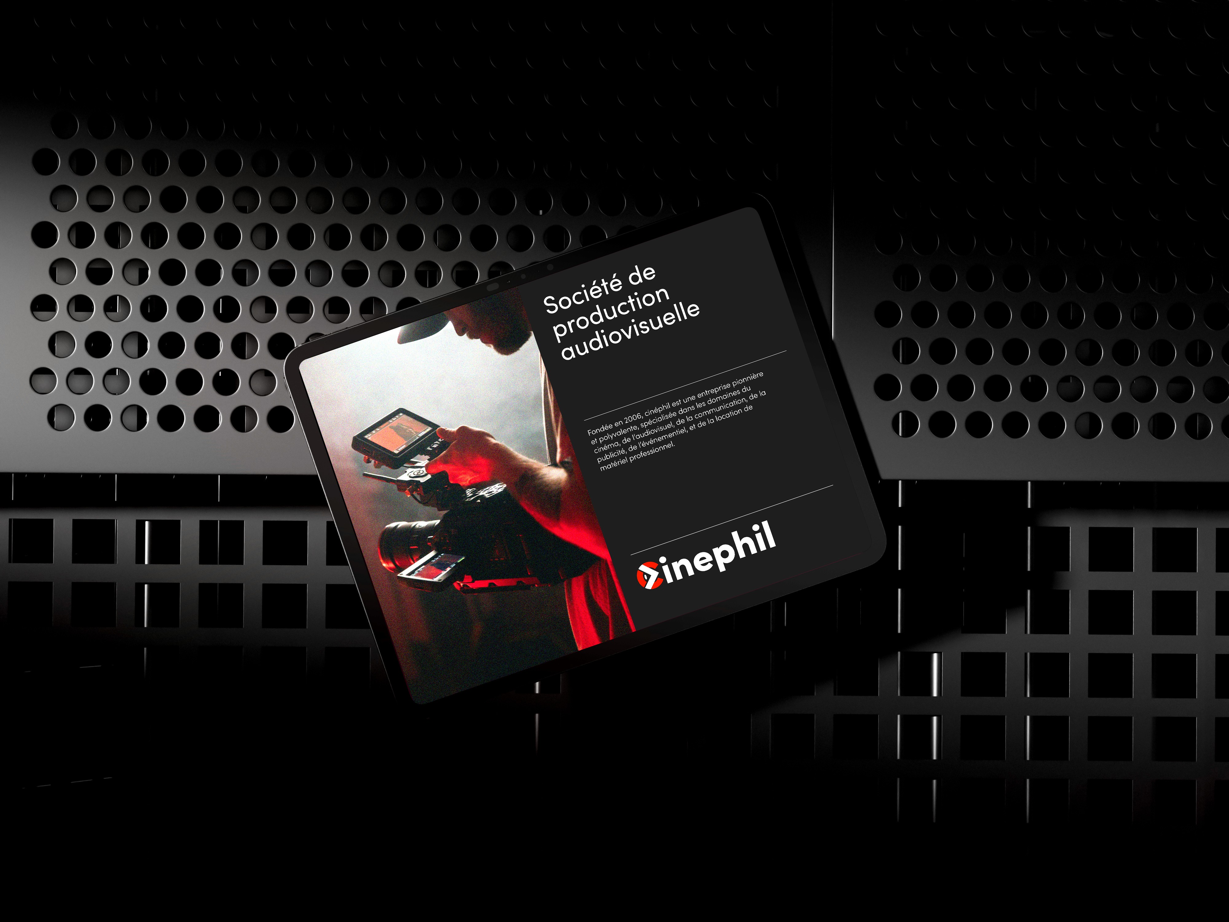 Modern home office setup with a monitor, ergonomic chair, keyboard, and indoor plants near a window with blinds.