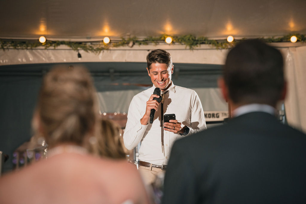 Wedding guest giving a speech into a microphone