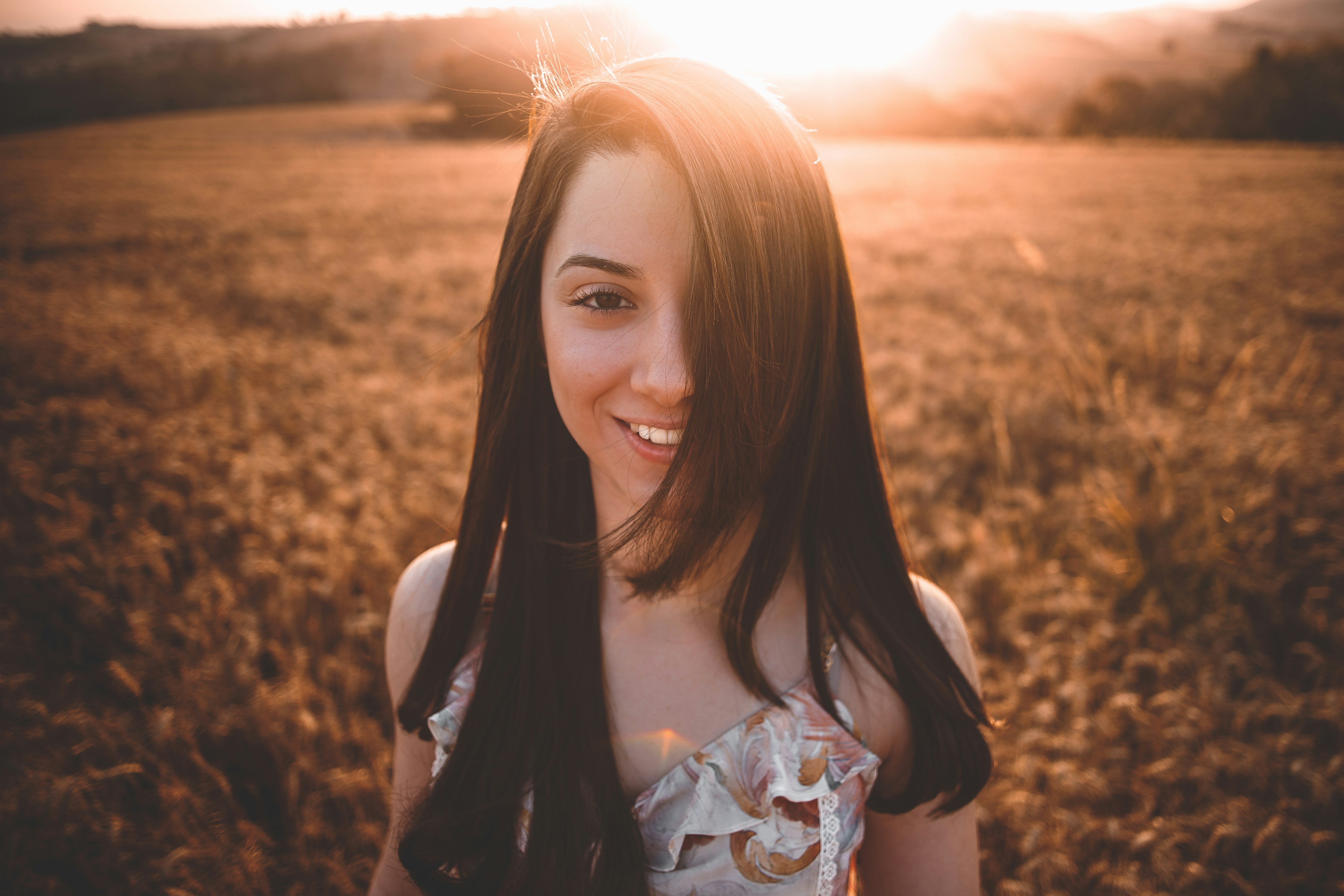 woman smiling under sun - Cool Skin Tone Colors To Wear