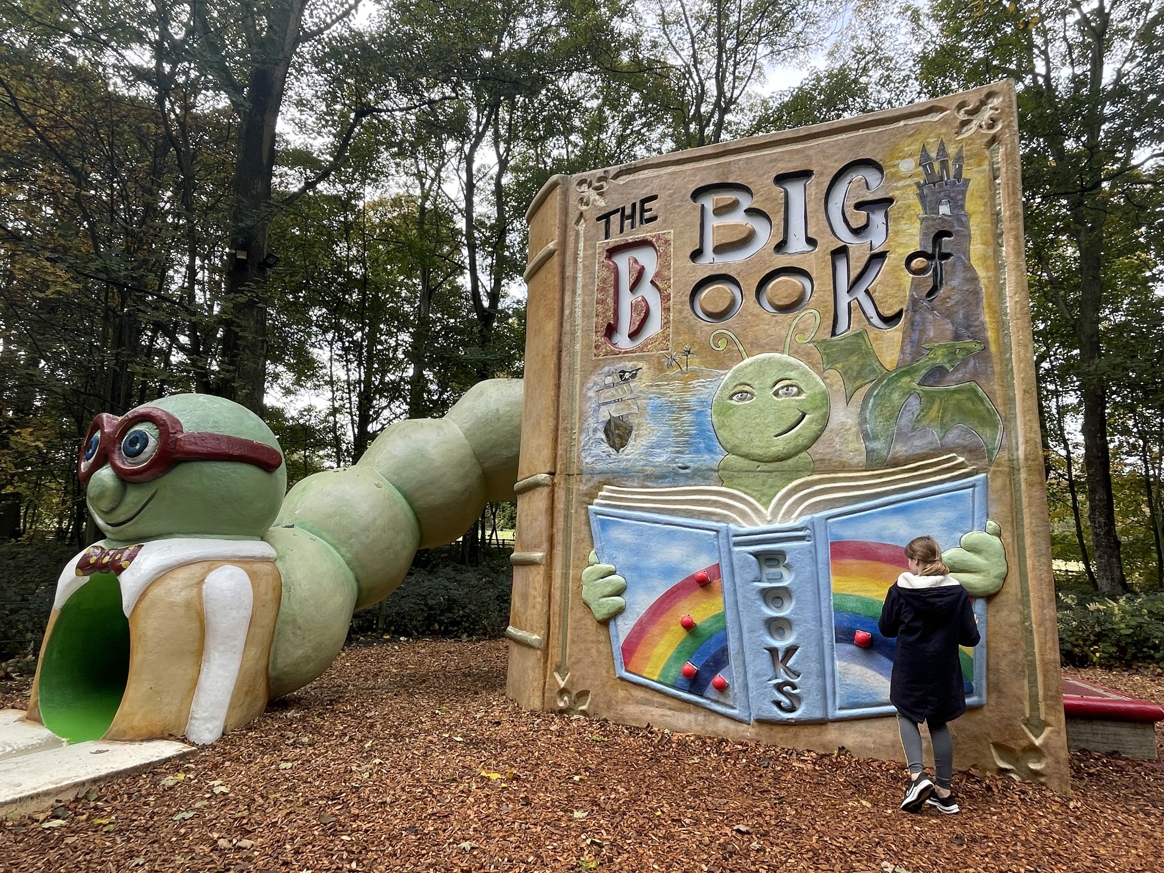 Giant storybook playground installation with bookworm slide and 'The Big Book' display