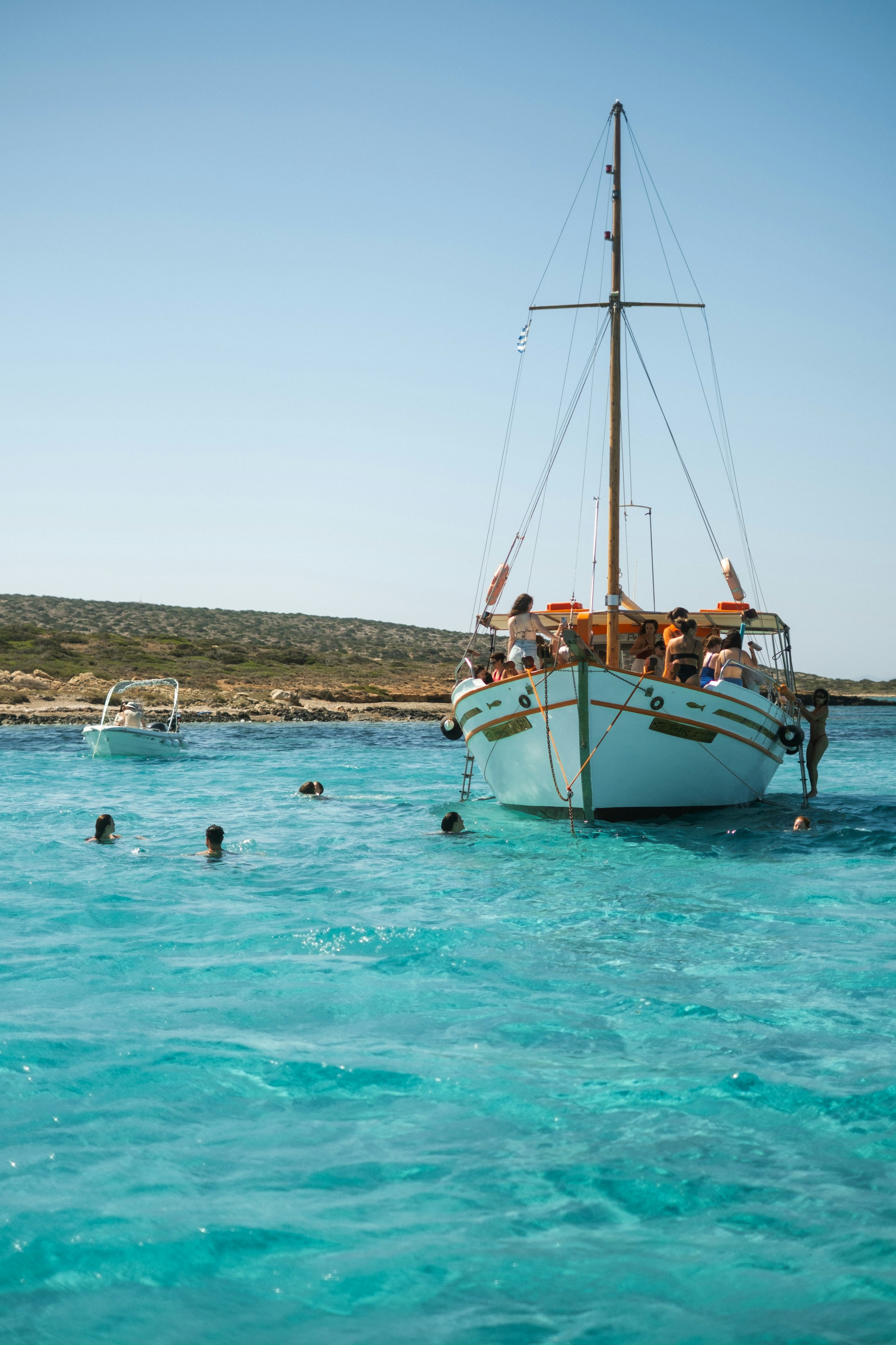 Clear blue water and a sailing boat near Antiparos