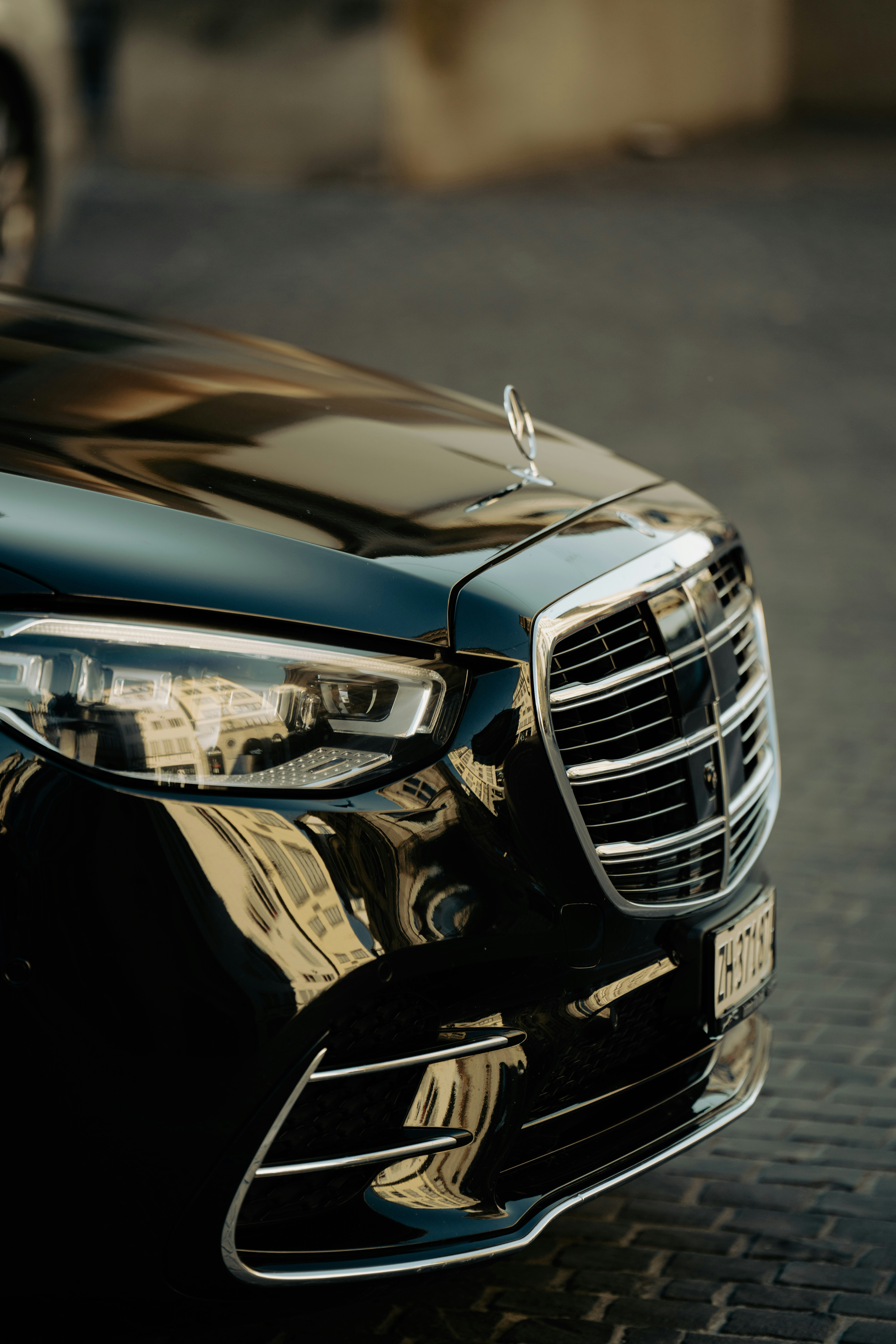 Professional chauffeur opening Mercedes door for passenger — premium Helsinki Airport private transfer service
