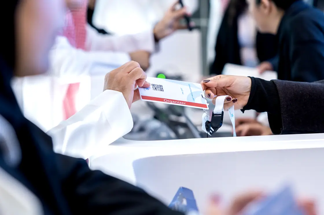 Employee giving a ticket to an event visitor