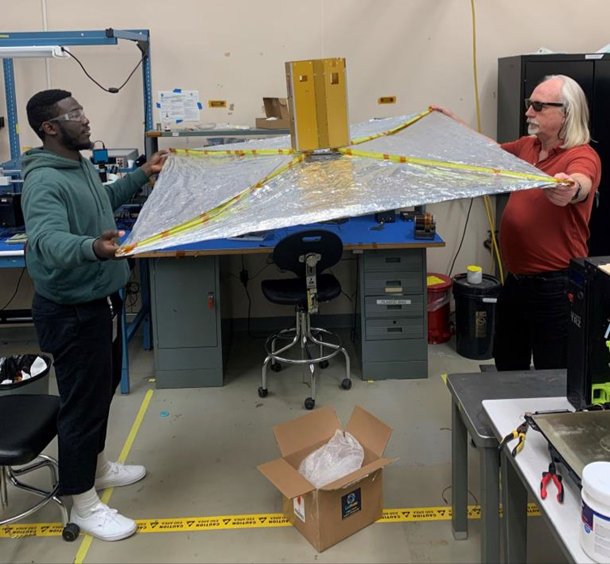 engineers inspecting the satellite