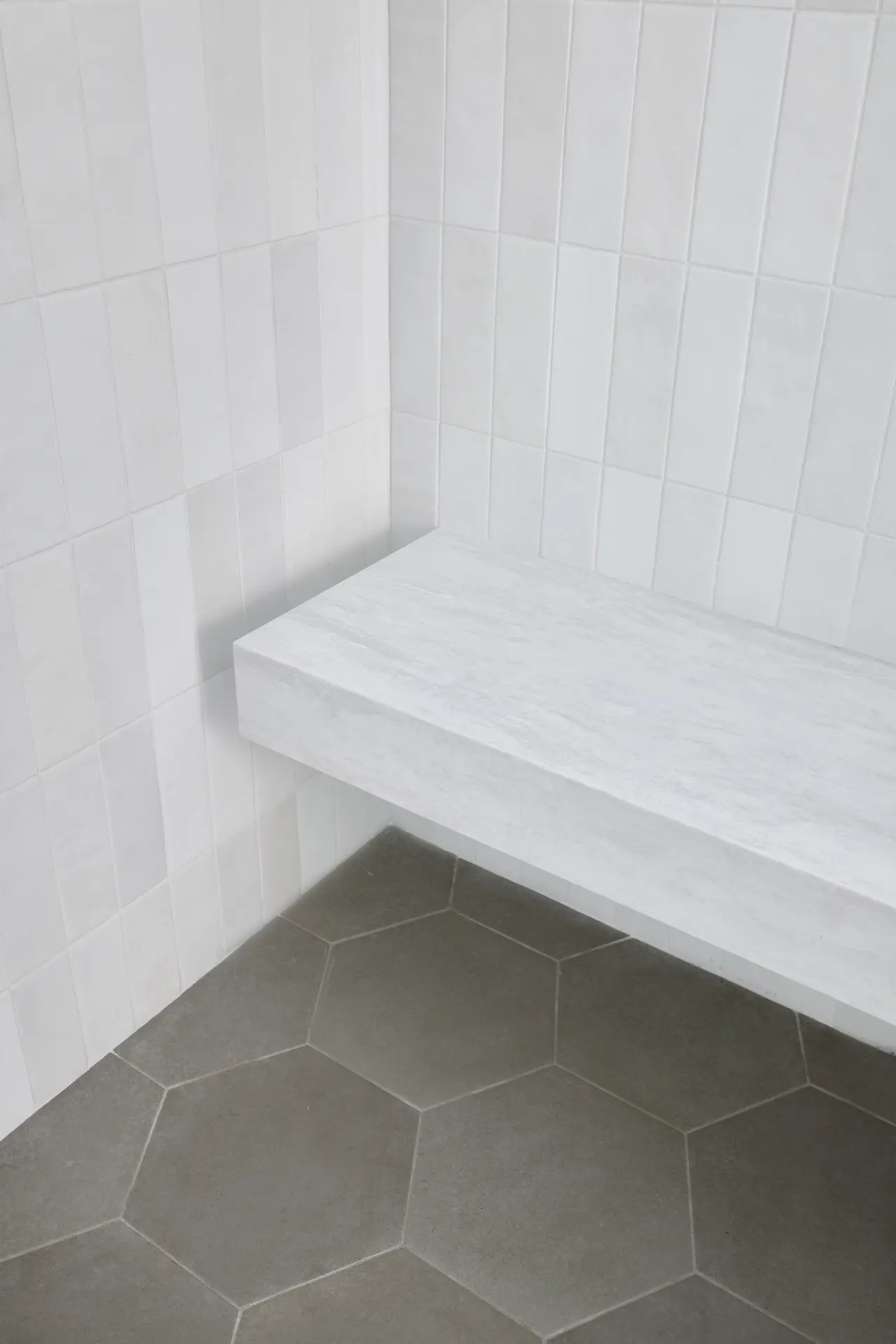 Portrait of the floating shower bench in ADU Orange, a modern touch in the traditionally inspired bathroom. Photo by Todd Huge.