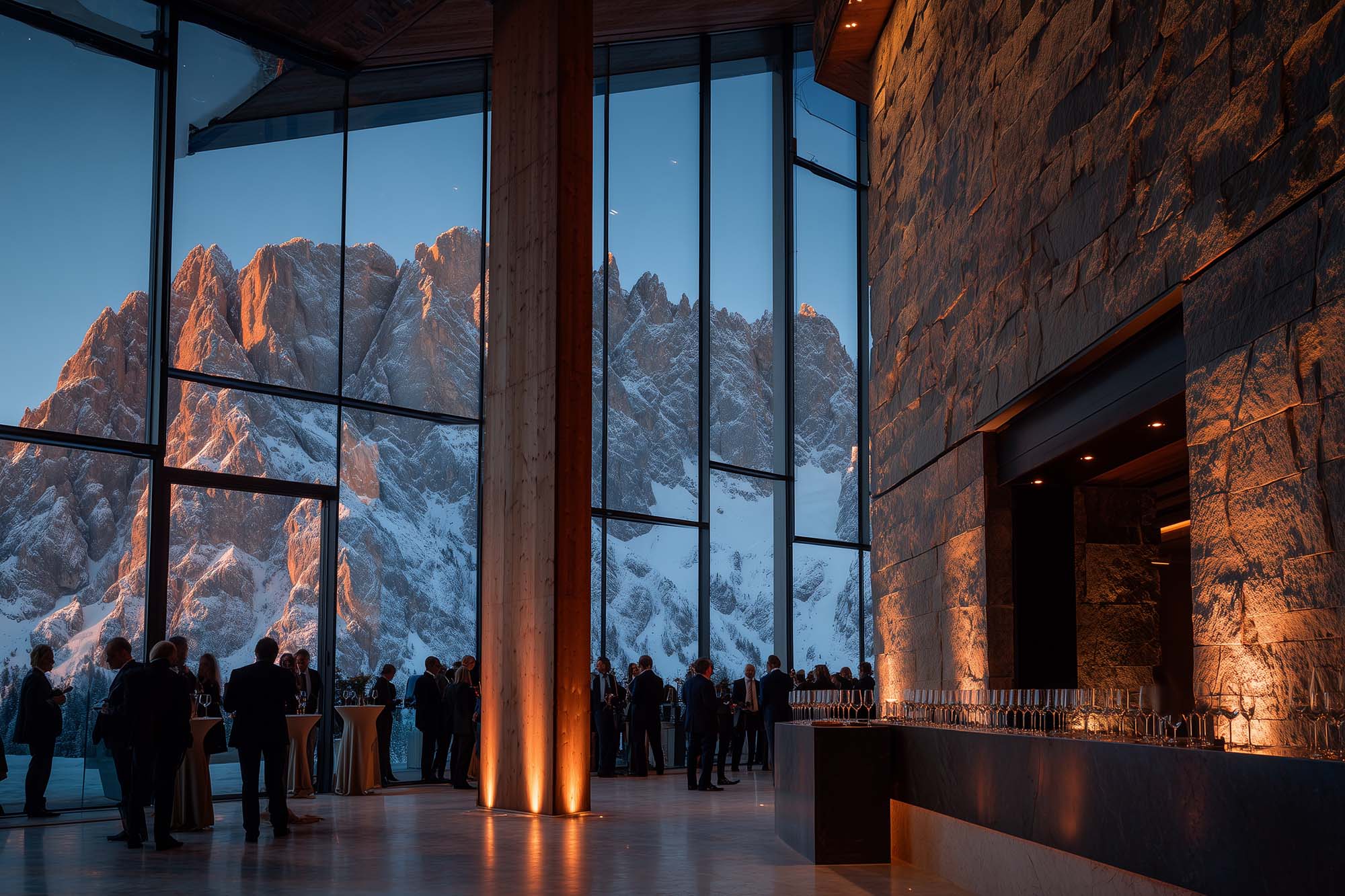 A modern interior with large glass windows, showcasing a mountain view and warm lighting 