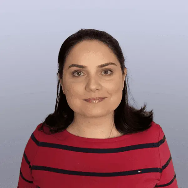 Woman in red and blue striped shirt smiling.