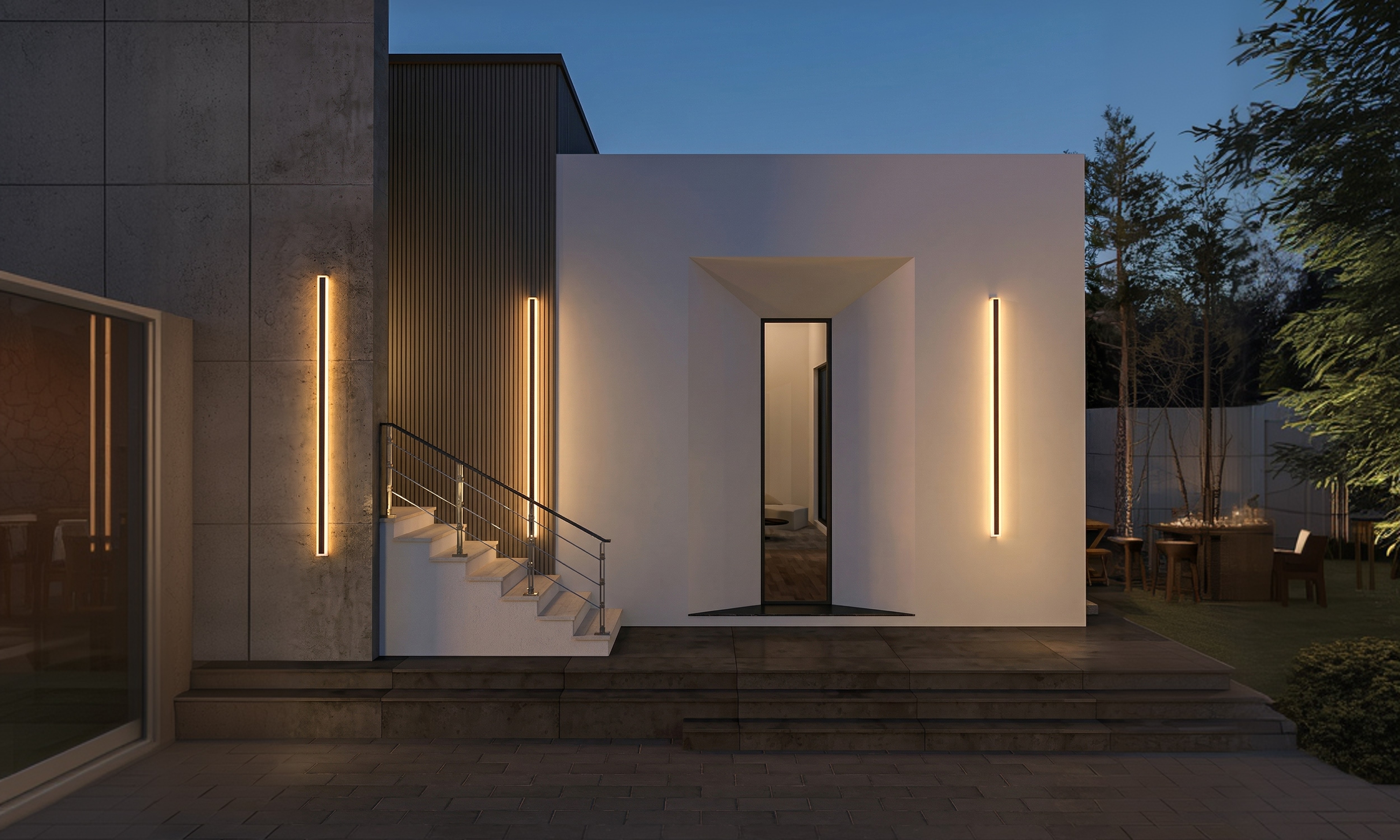 Exterior view of Kōan House at dusk, a minimalist Japanese concrete residence with vertical amber light strips flanking the entrance