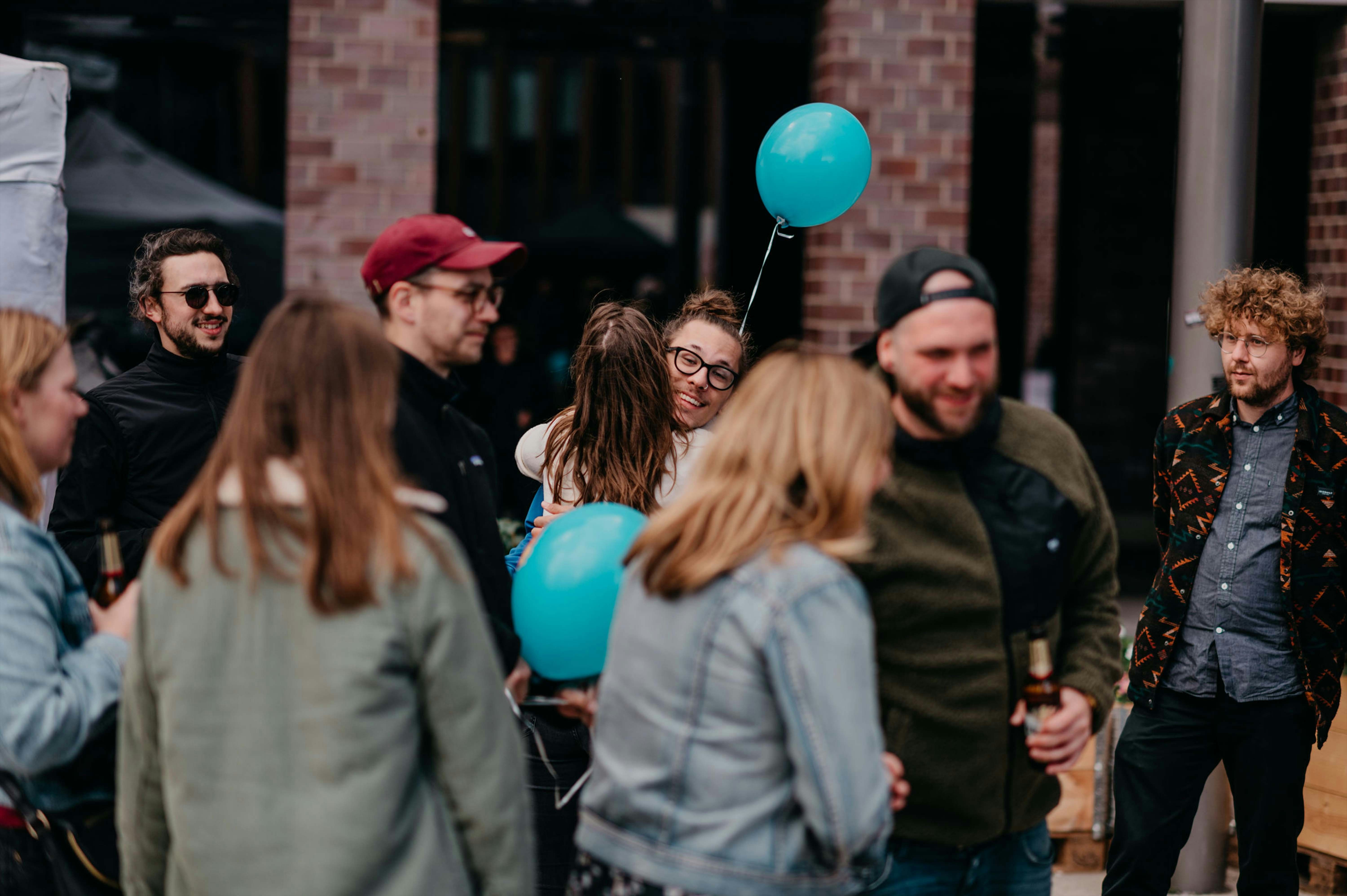 man in black crew neck t-shirt and blue shorts holding woman in white and red