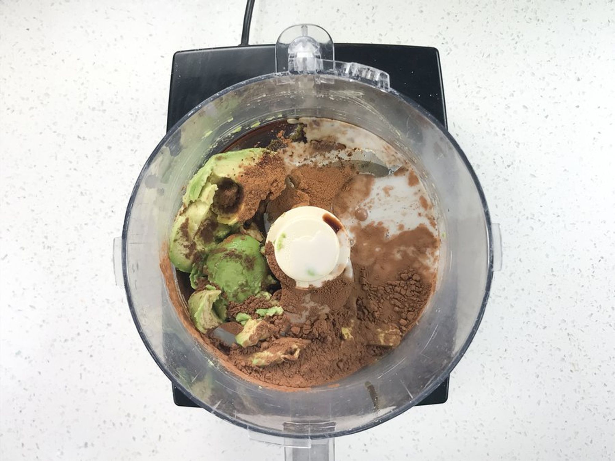 ingredients for avocado chocolate mousse in a food processor