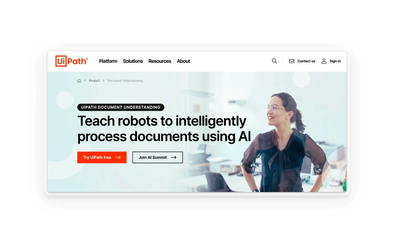 A webpage header for UiPath, featuring the tagline "Teach robots to intelligently process documents using AI" with a background image of a smiling woman in an office.