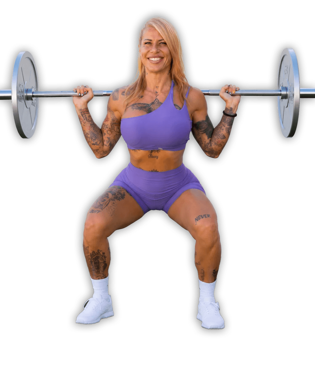 Bearded man in headband joyfully overhead pressing barbell in squat.