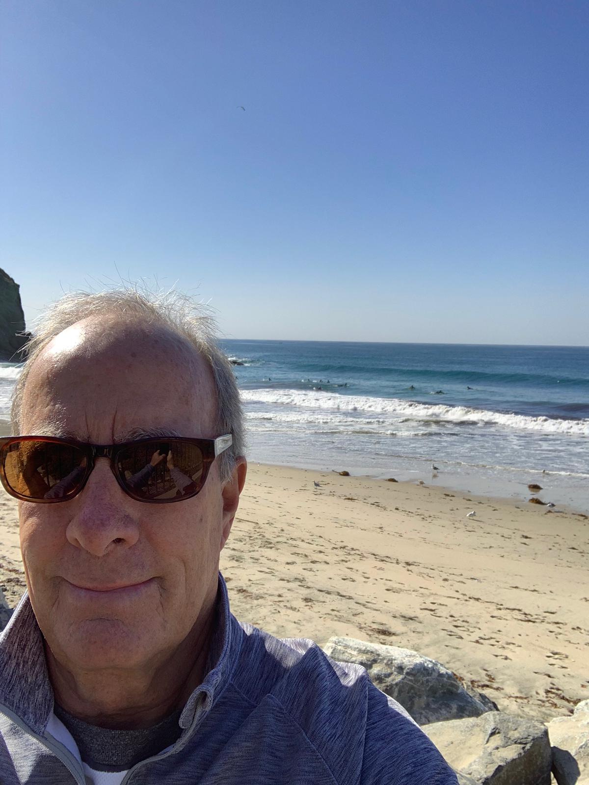 smiling woman wearing white and black pinstriped collared top
