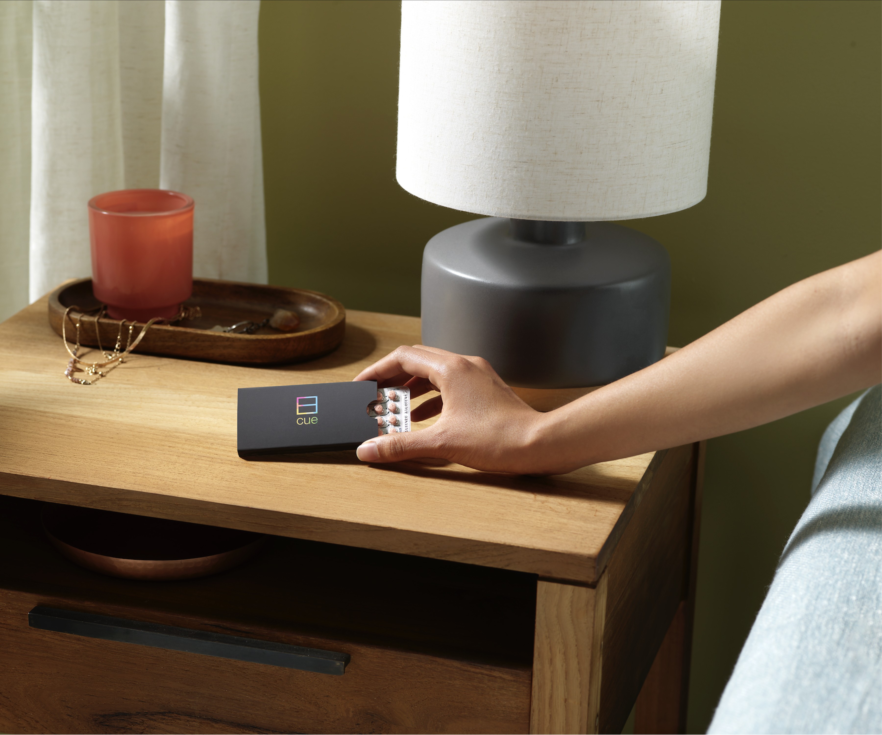 Minimal plant cutting with exposed roots in a clear glass bowl vase filled with water on a white background.