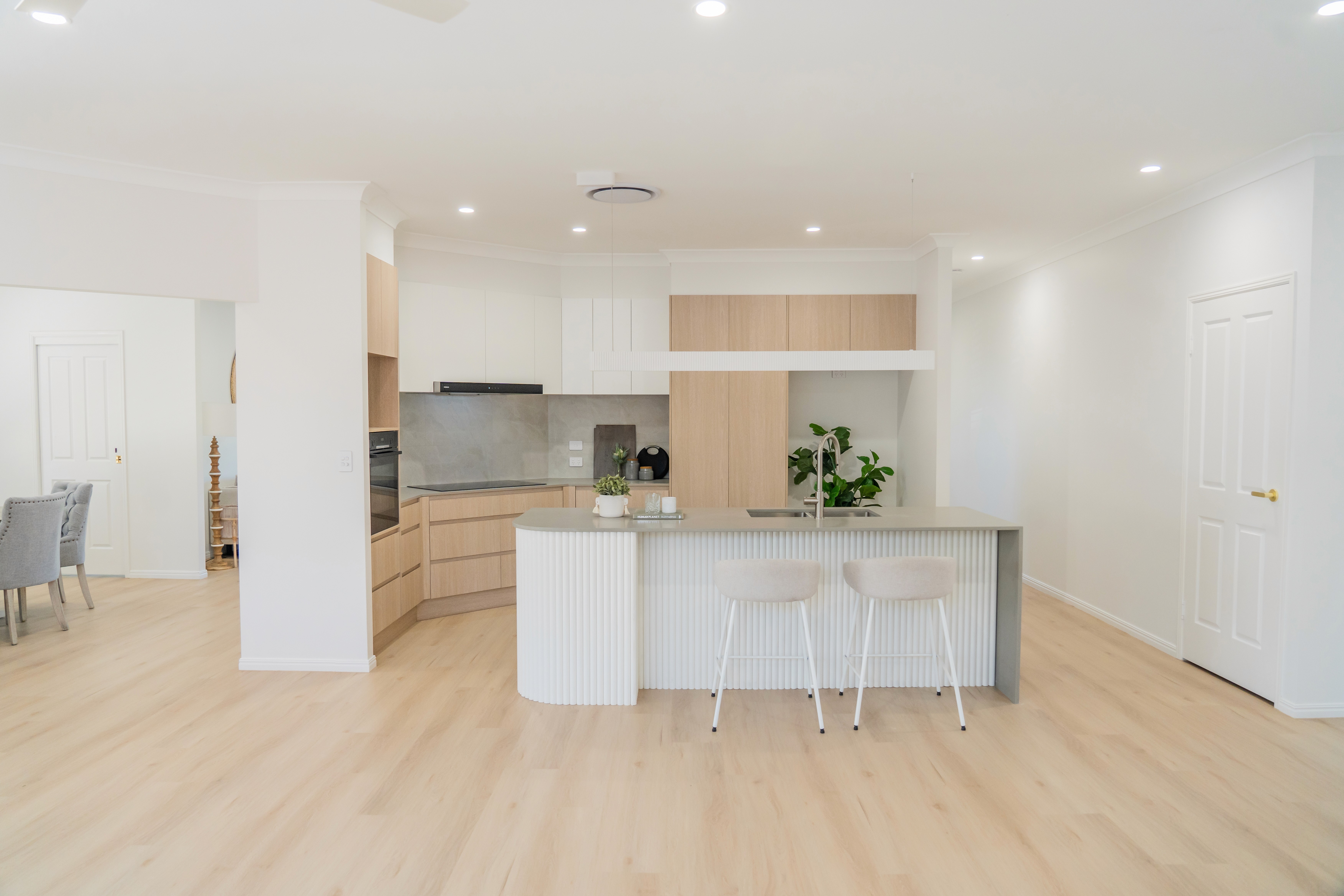 people walking on the beach in front of a city