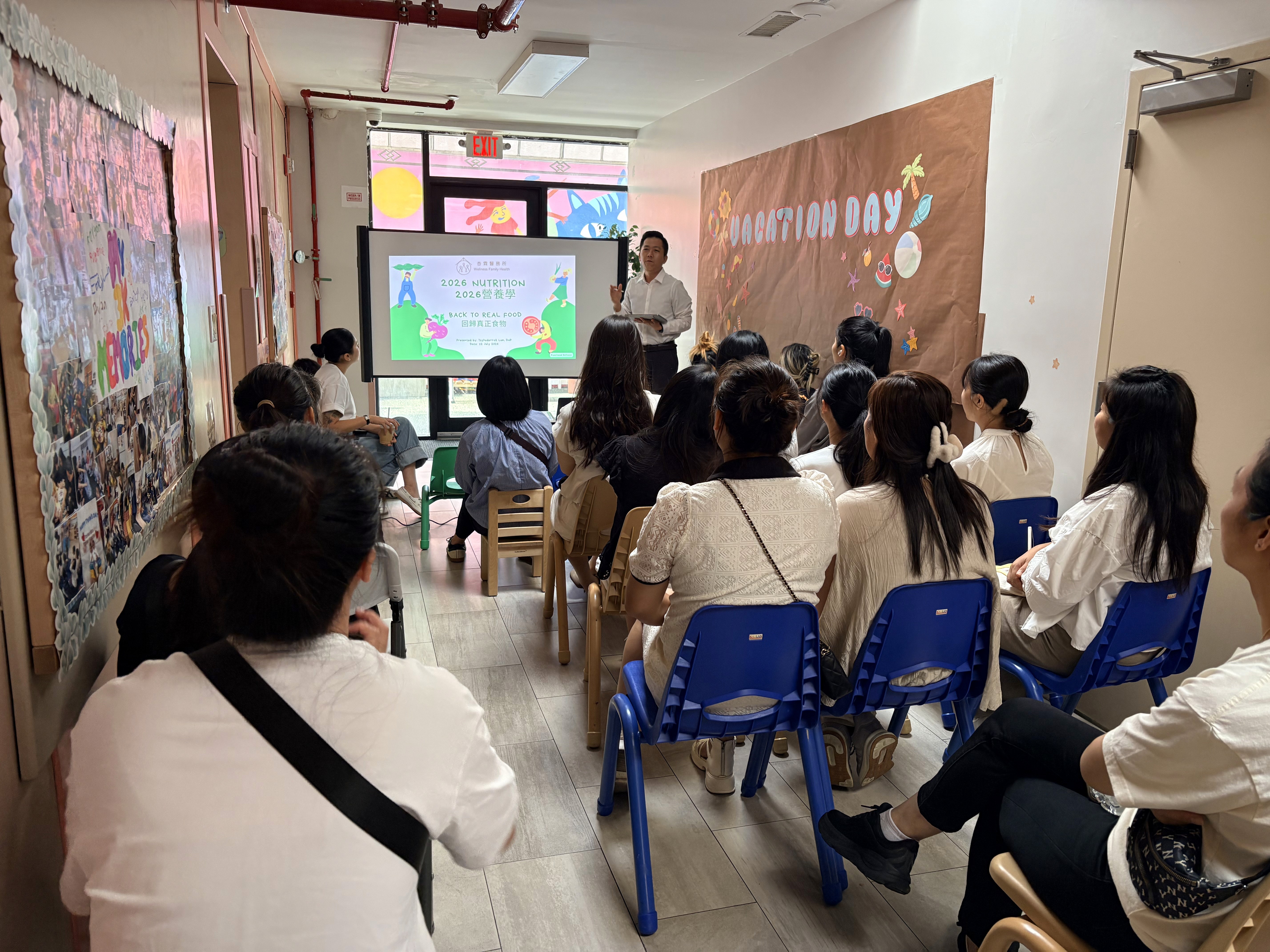Parents listen intently to a nutrition workshop presented by a doctor.