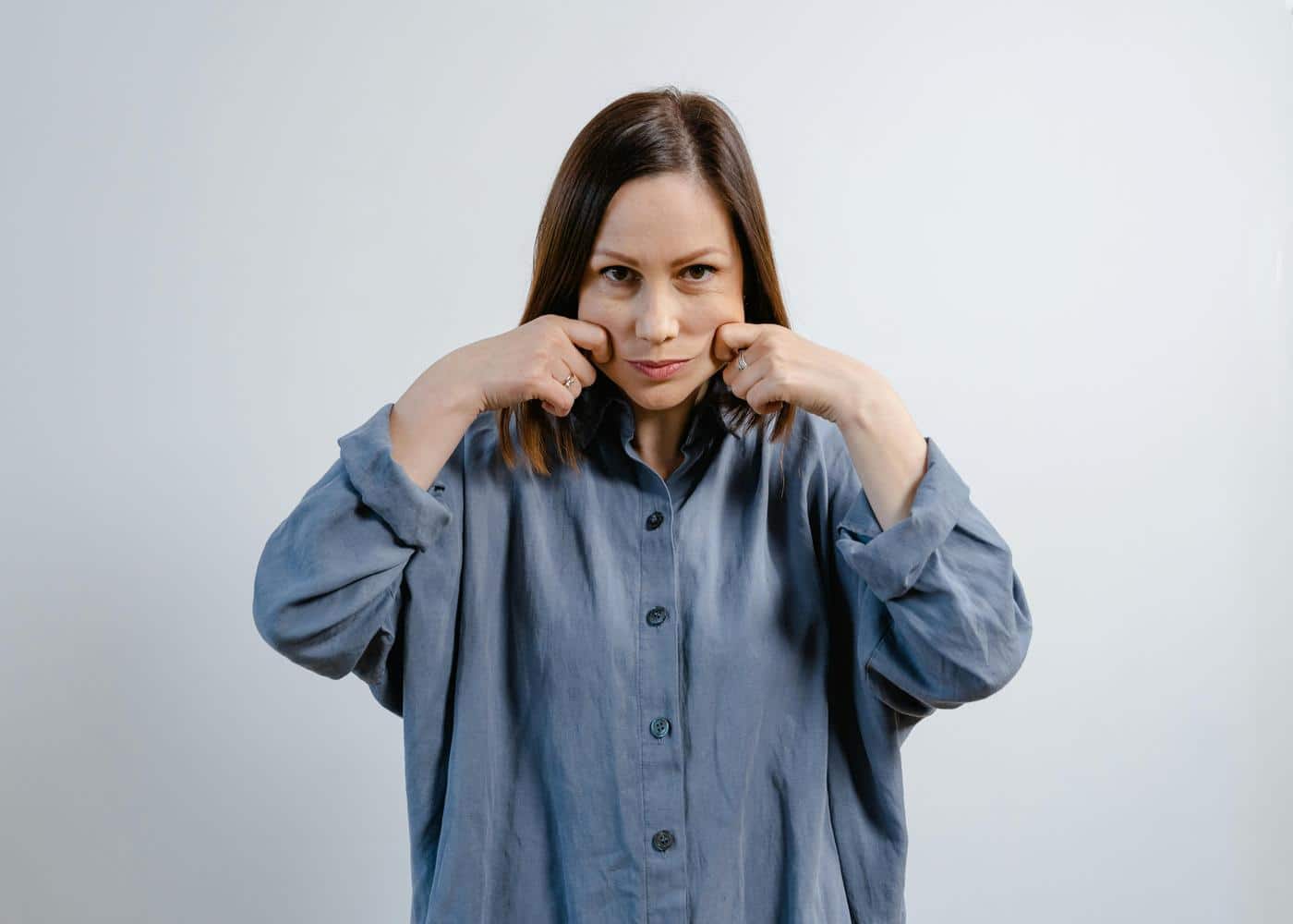Woman doing an anti-inflammation facial massage with her fingers