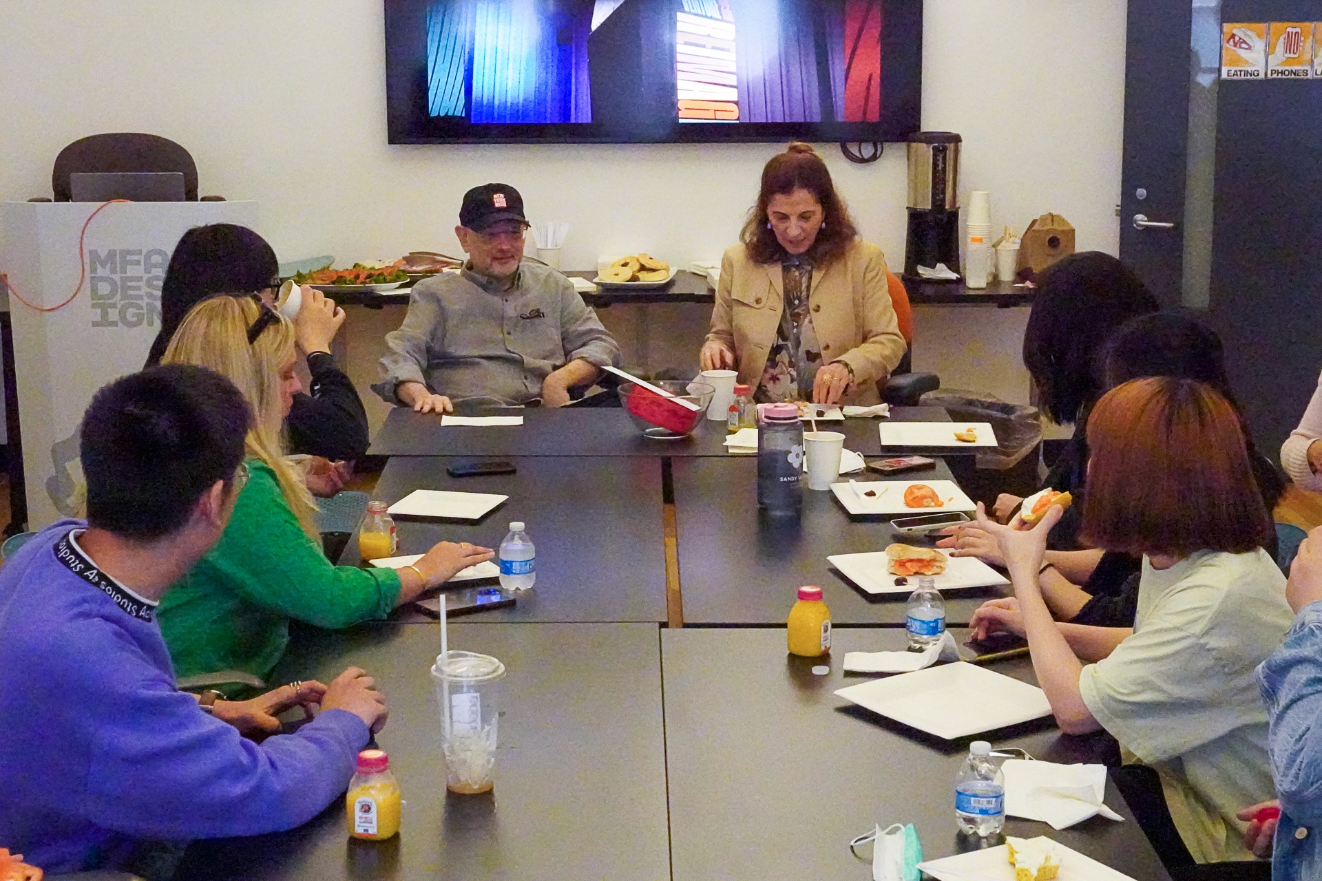 A photo of a group of people sitting at a conference table in an office room.