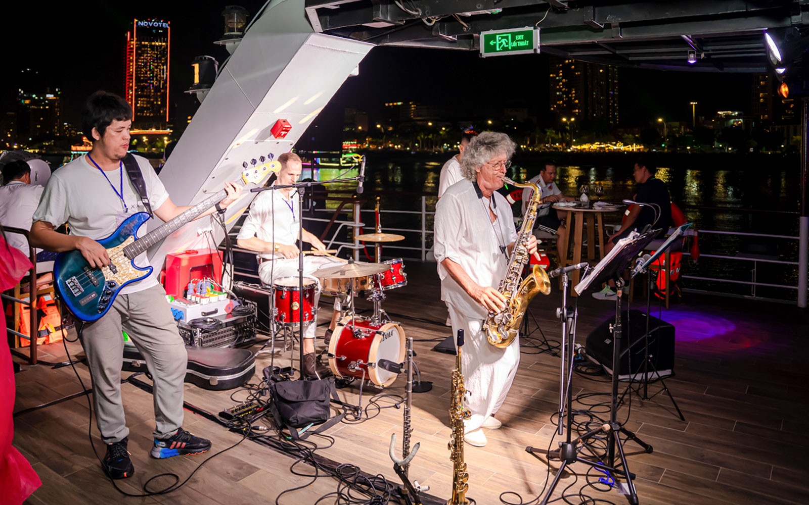 Live band performing on the deck of Poseidon Cruise at night.
