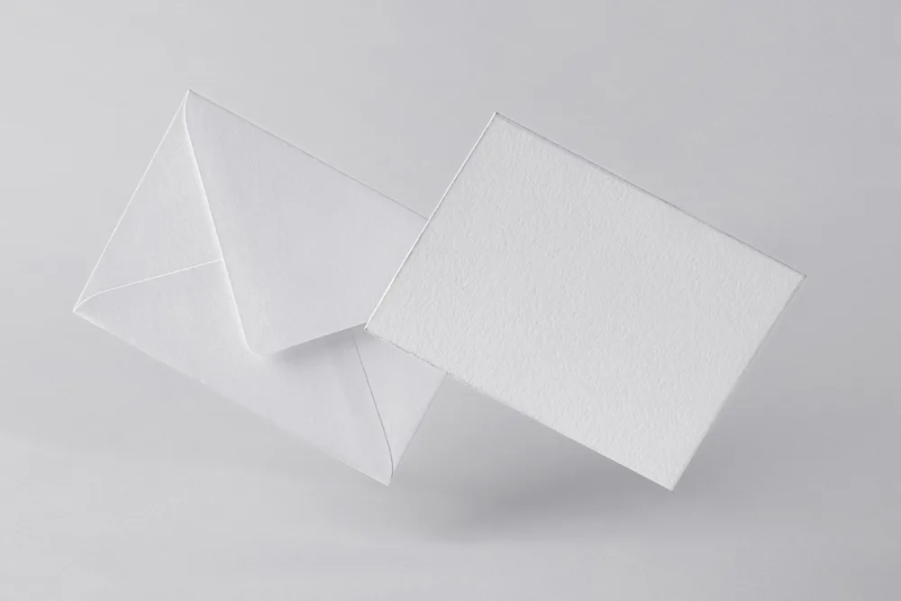 Envelope and invitation card mockup featuring a black design with vibrant abstract patterns in green, blue, and purple. Displayed on a dark background with minimal lighting for a sleek and modern look.