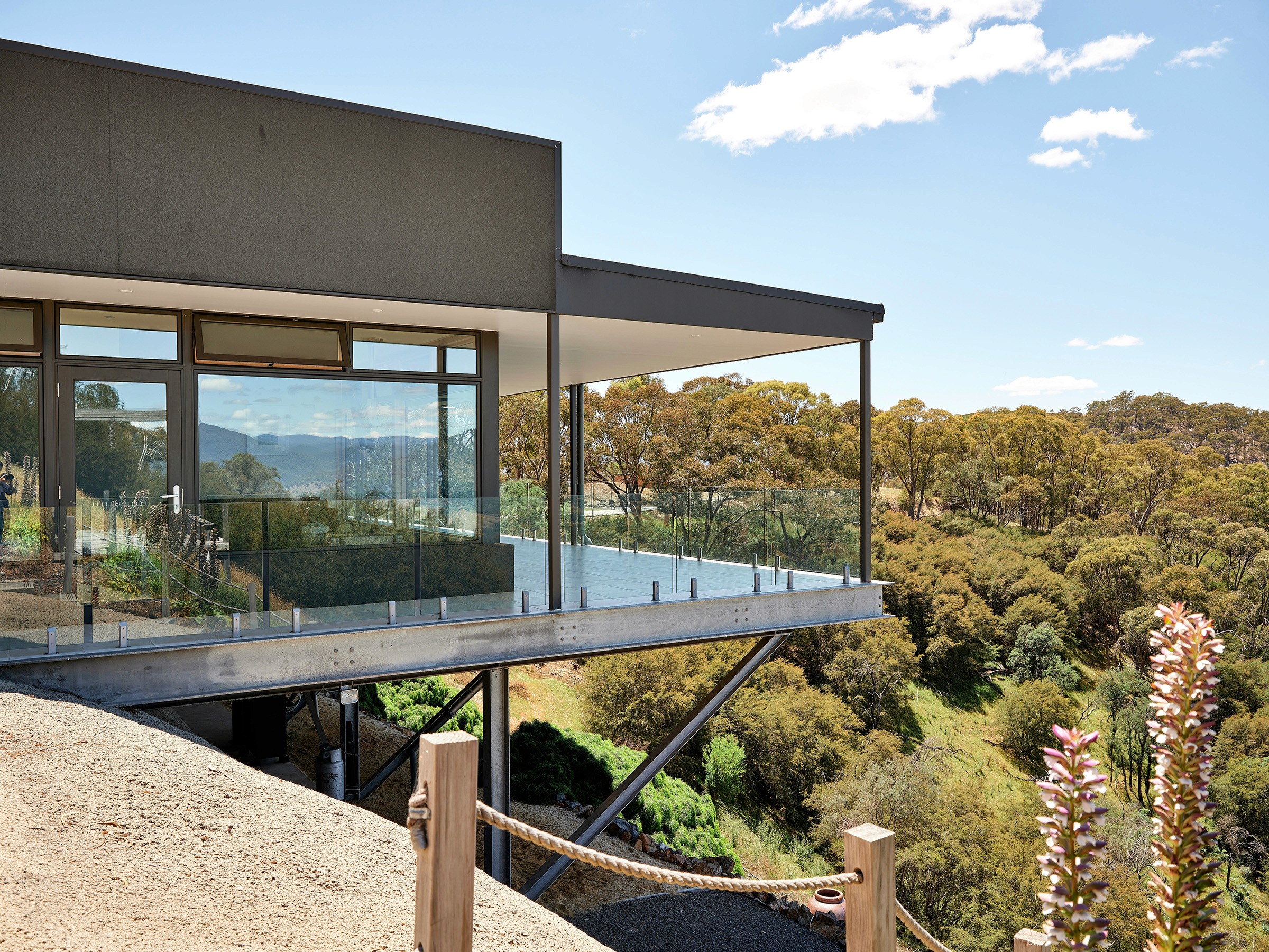 Elevated house with glass railings and scenic views