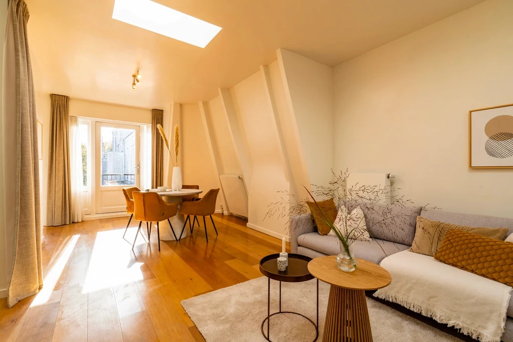 Attic living room with skylights and a dining corner