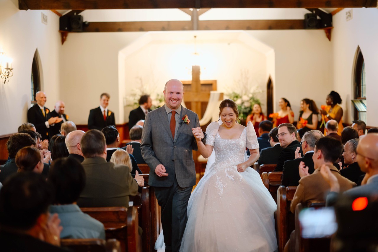 Bride and groom walking down the aisle at their Catholic church wedding ceremony in Melbourne