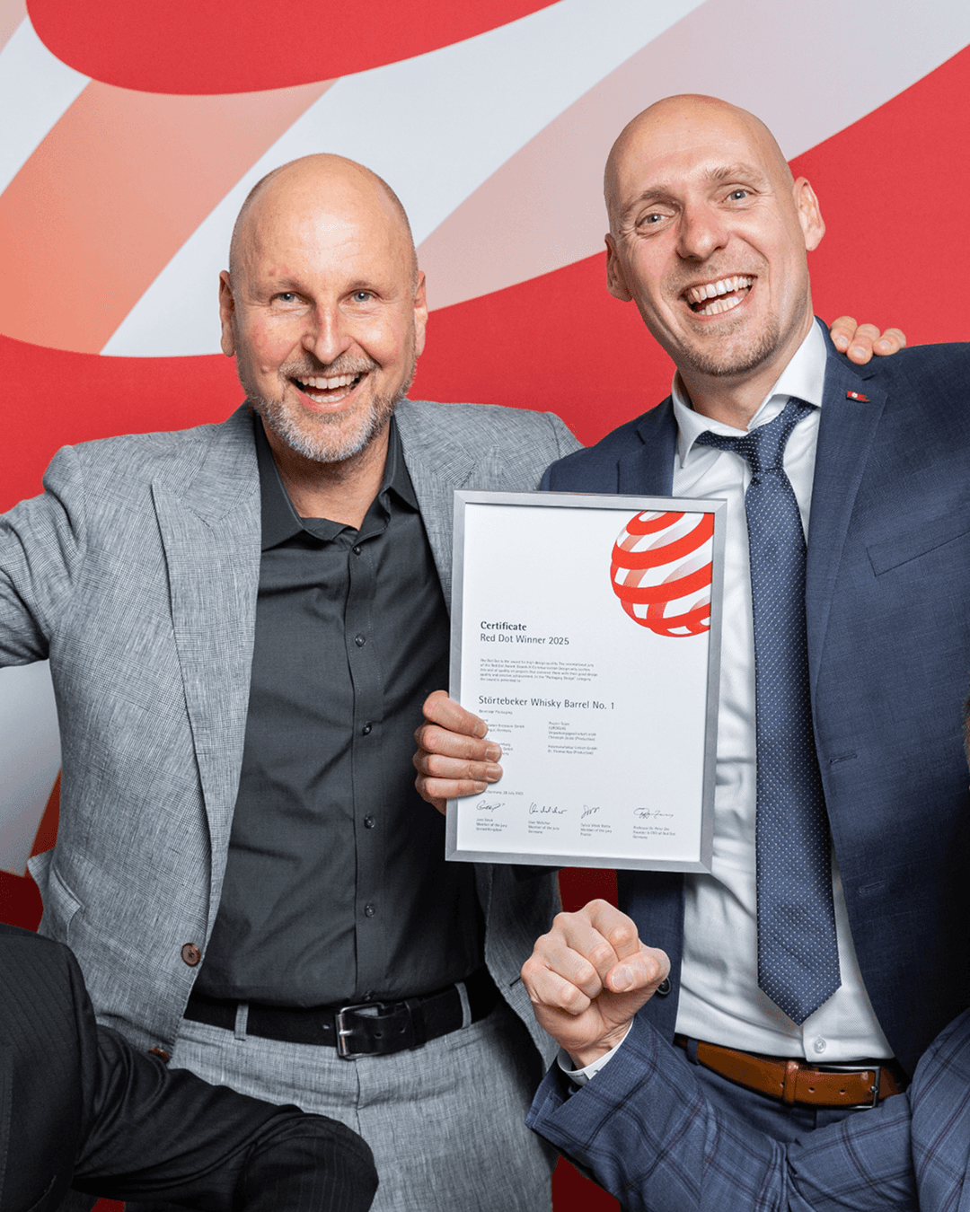 Men with award certificate, smiling