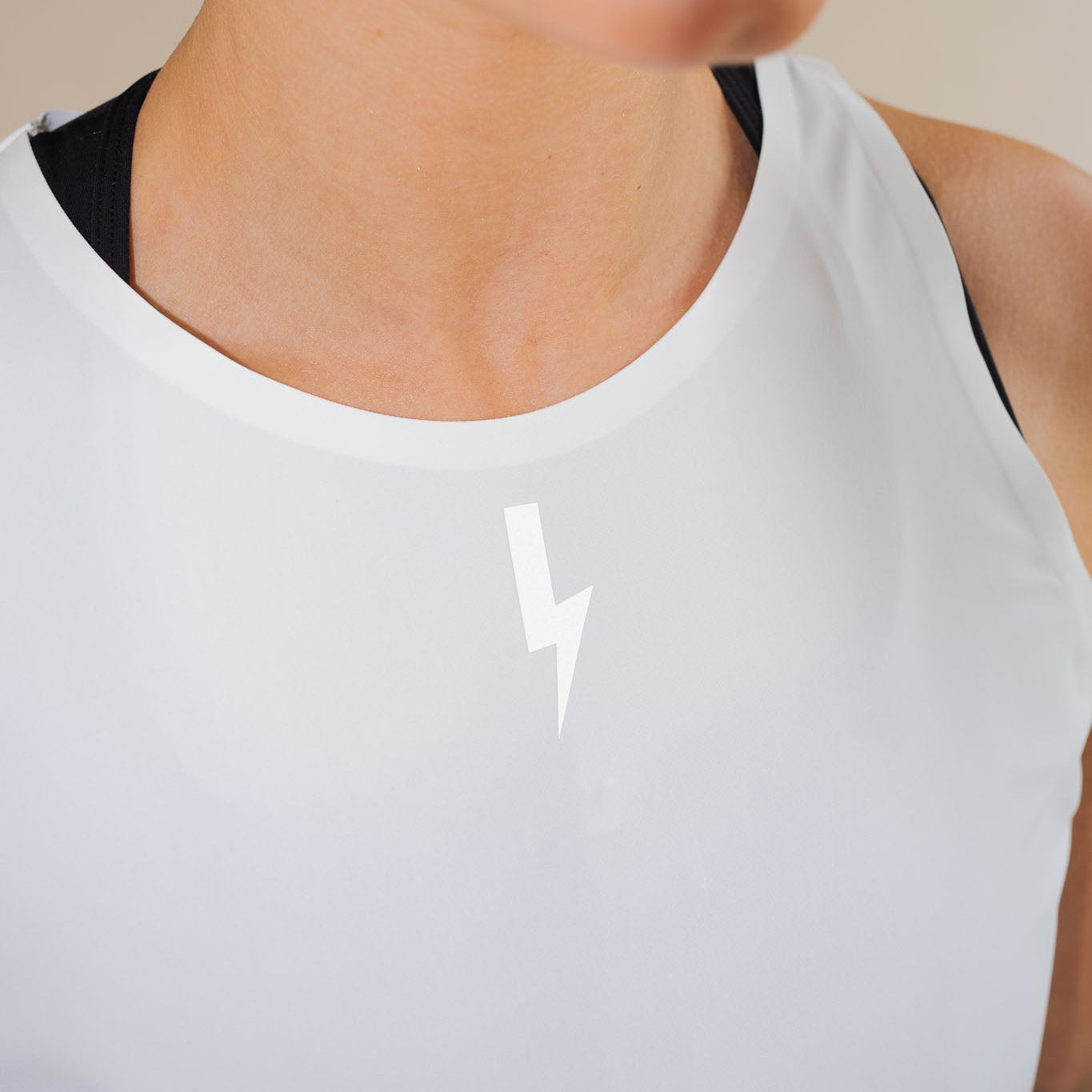 LUCA bolt logo on Meander vest in white, neckline close-up