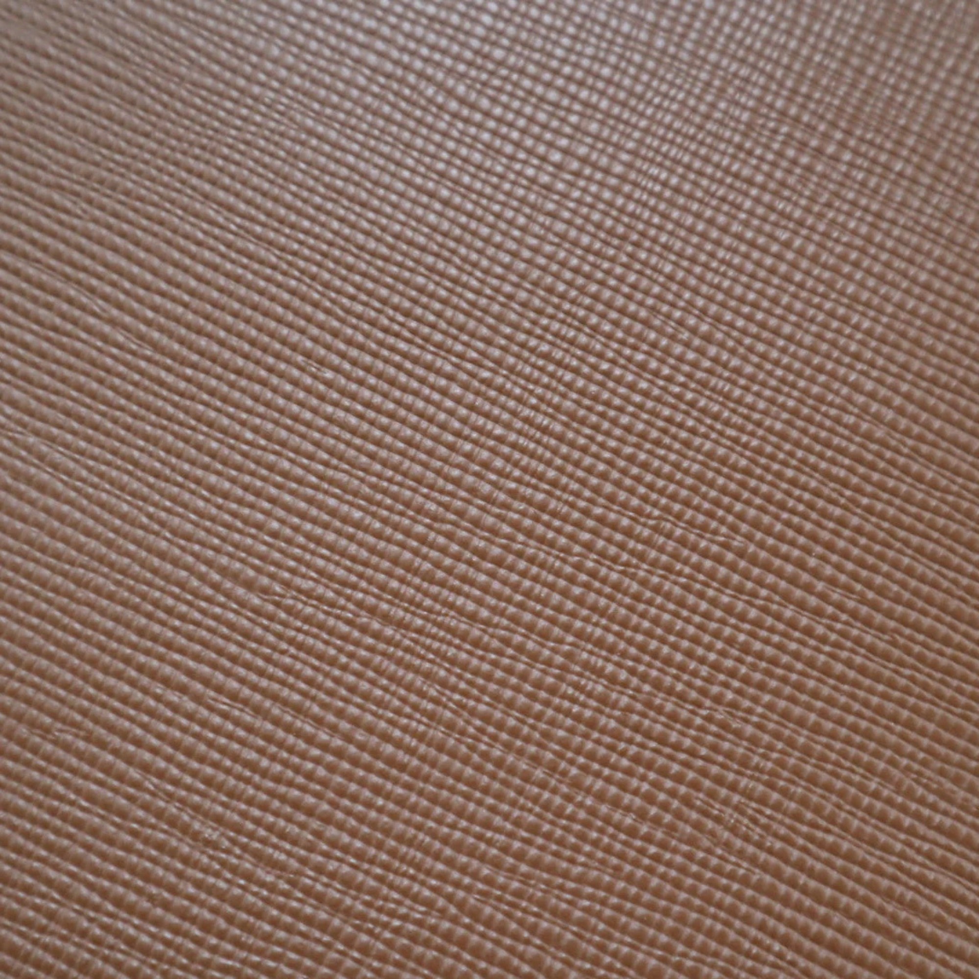 Aged leather background with a stitched border and brass studs