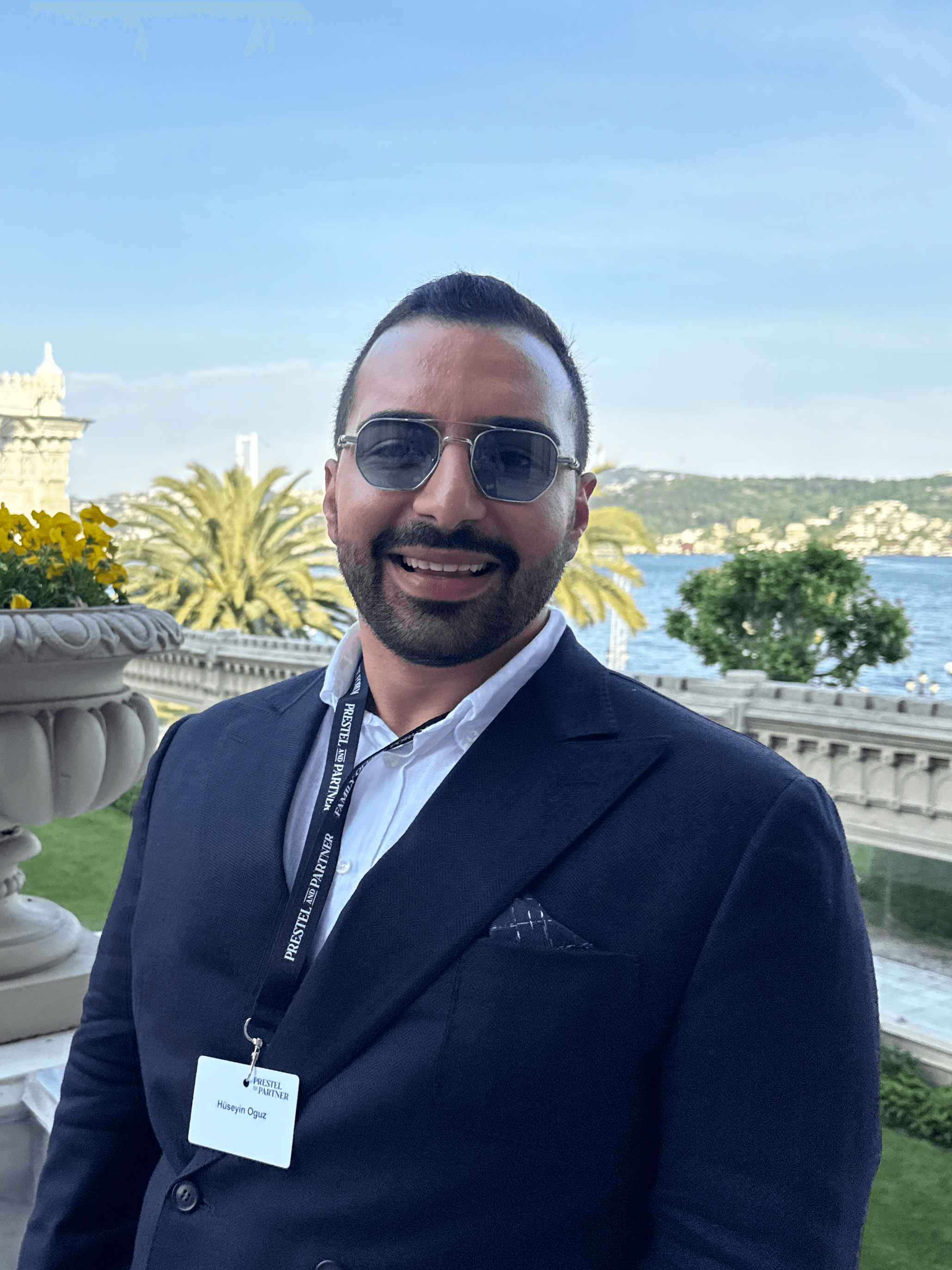 A young person with long, wavy hair sits in front of a plain background, looking directly at the camera.