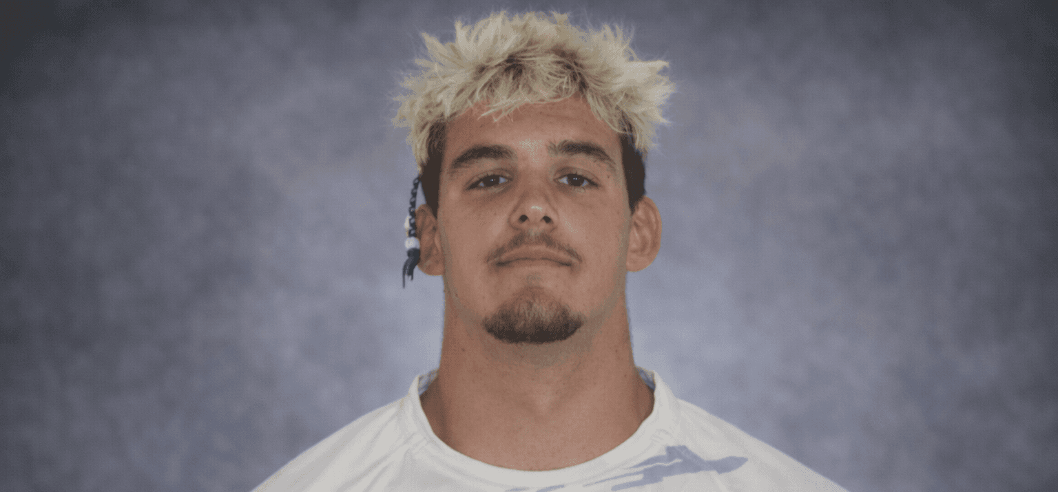 smiling woman wearing white and black pinstriped collared top