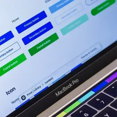 Detail of a MacBook Pro with variations in the buttons of a design system.