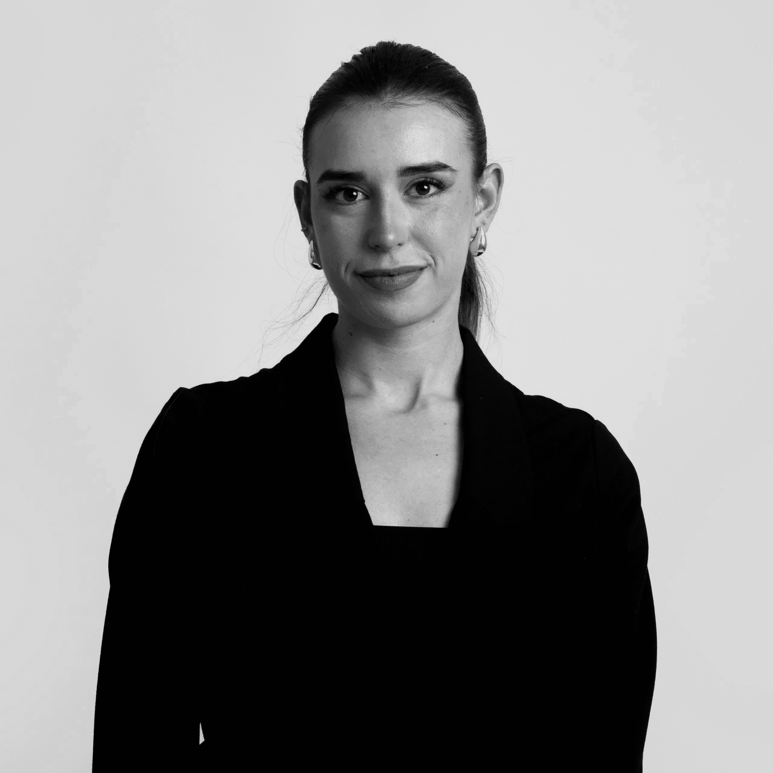 Black and white portrait of a smiling person with curly hair