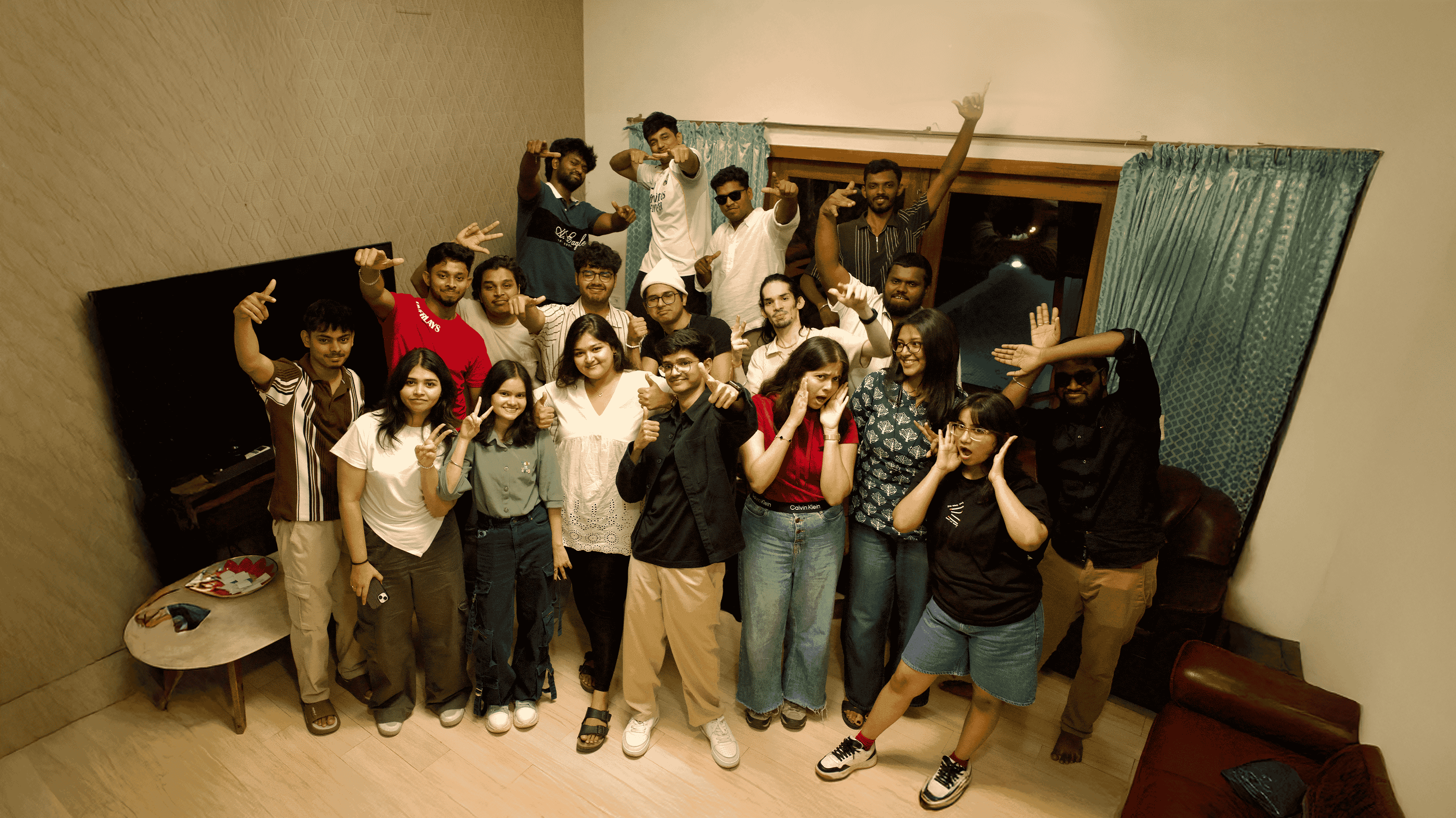 Three people sitting on a couch in a room looking at mobile devices