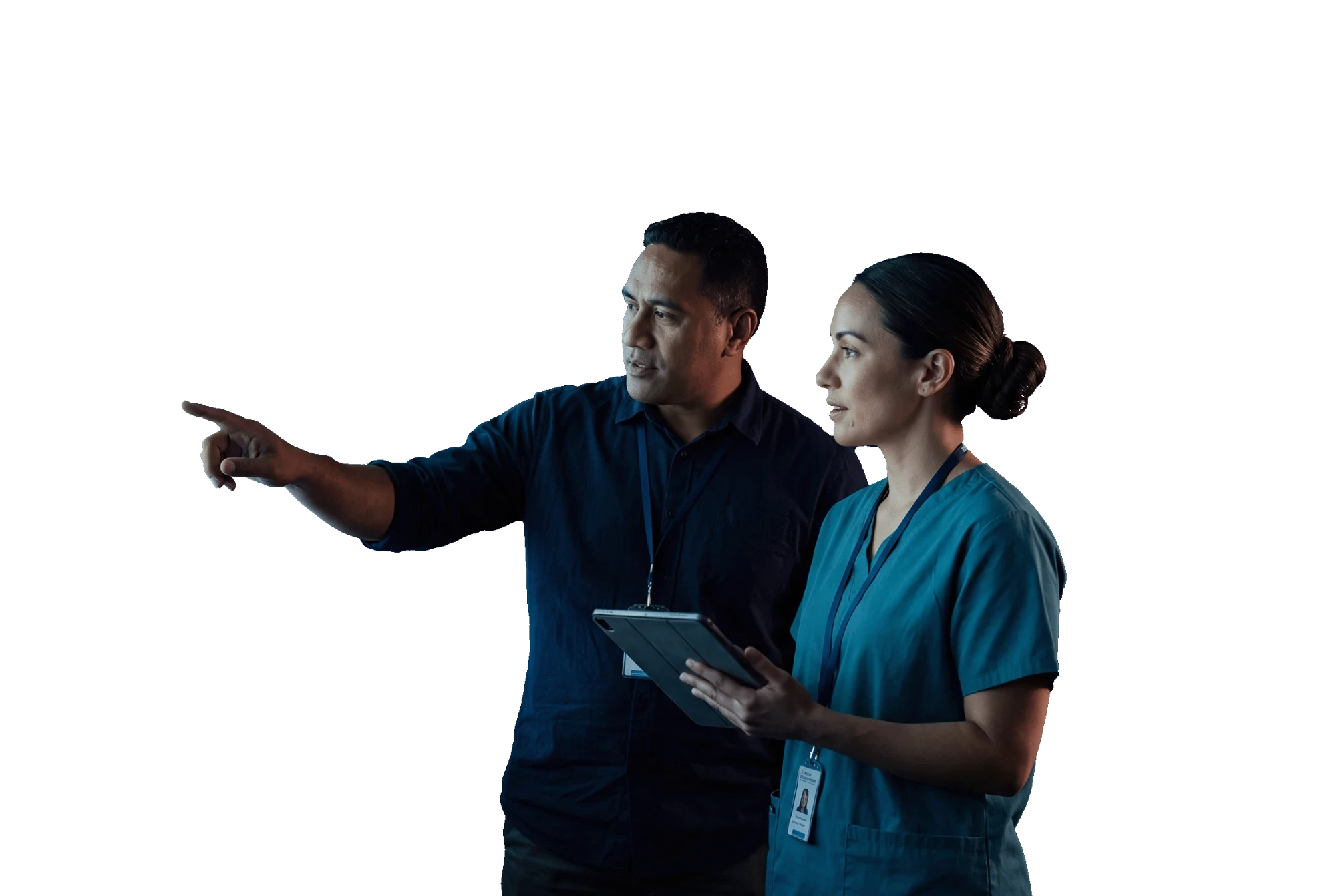 Operations manager and nurse unit manager reviewing patient flow on a wall of screens