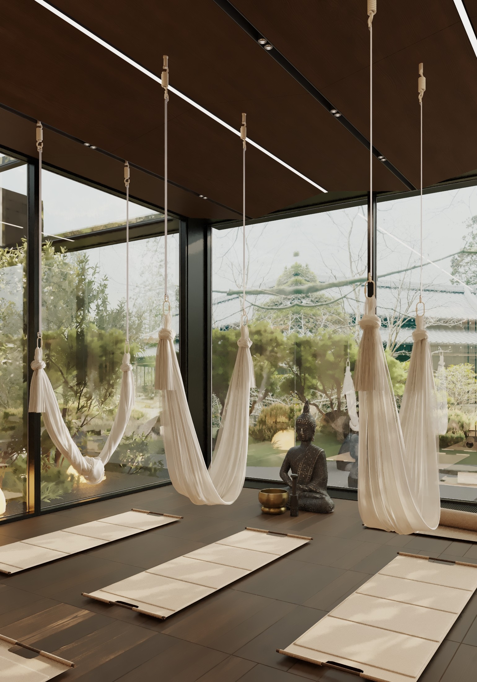 Aerial yoga studio with hammocks, yoga mats, and a Buddha statue.