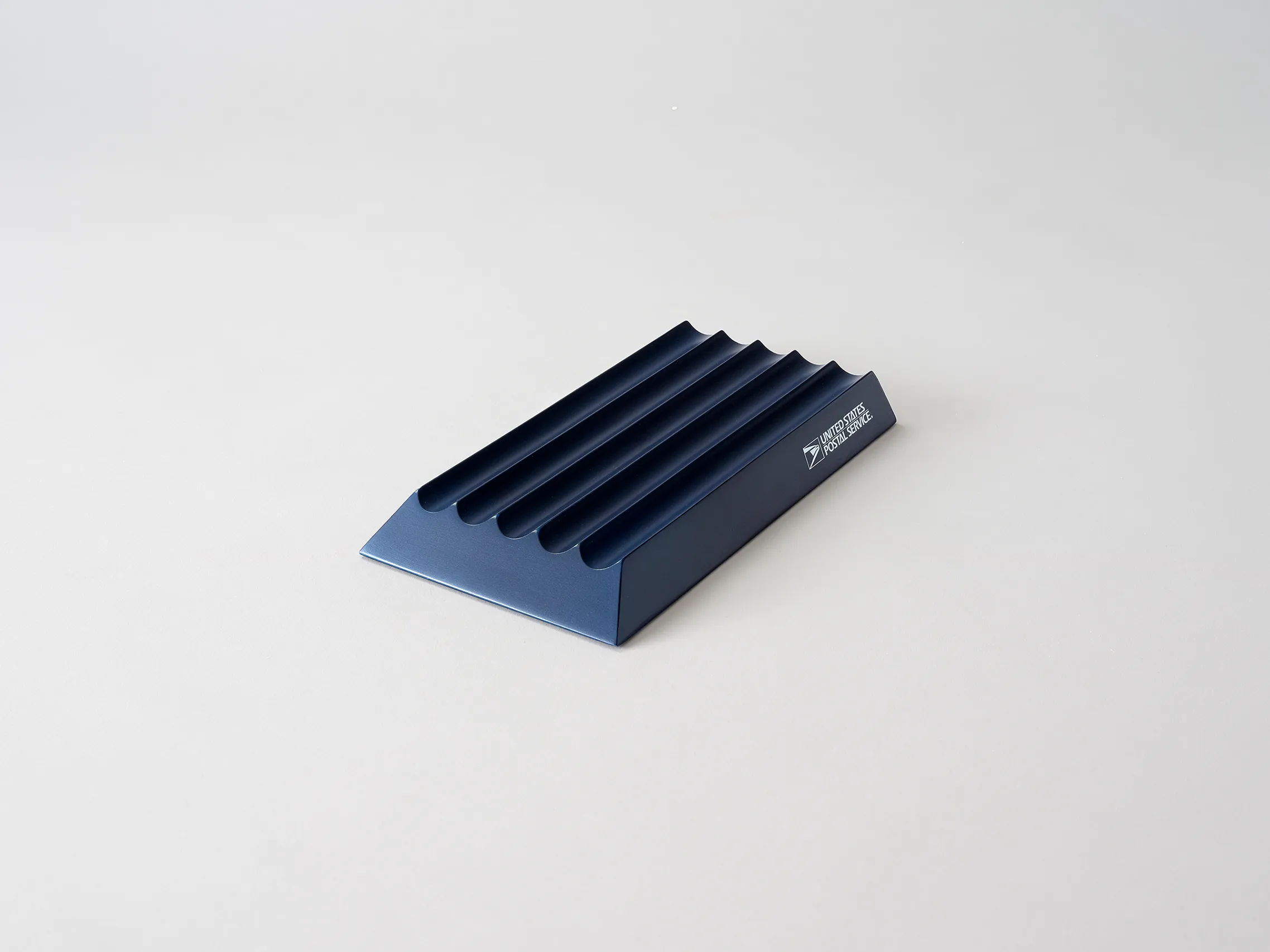 Dark blue USPS mailbox sensor shown from a low angled perspective