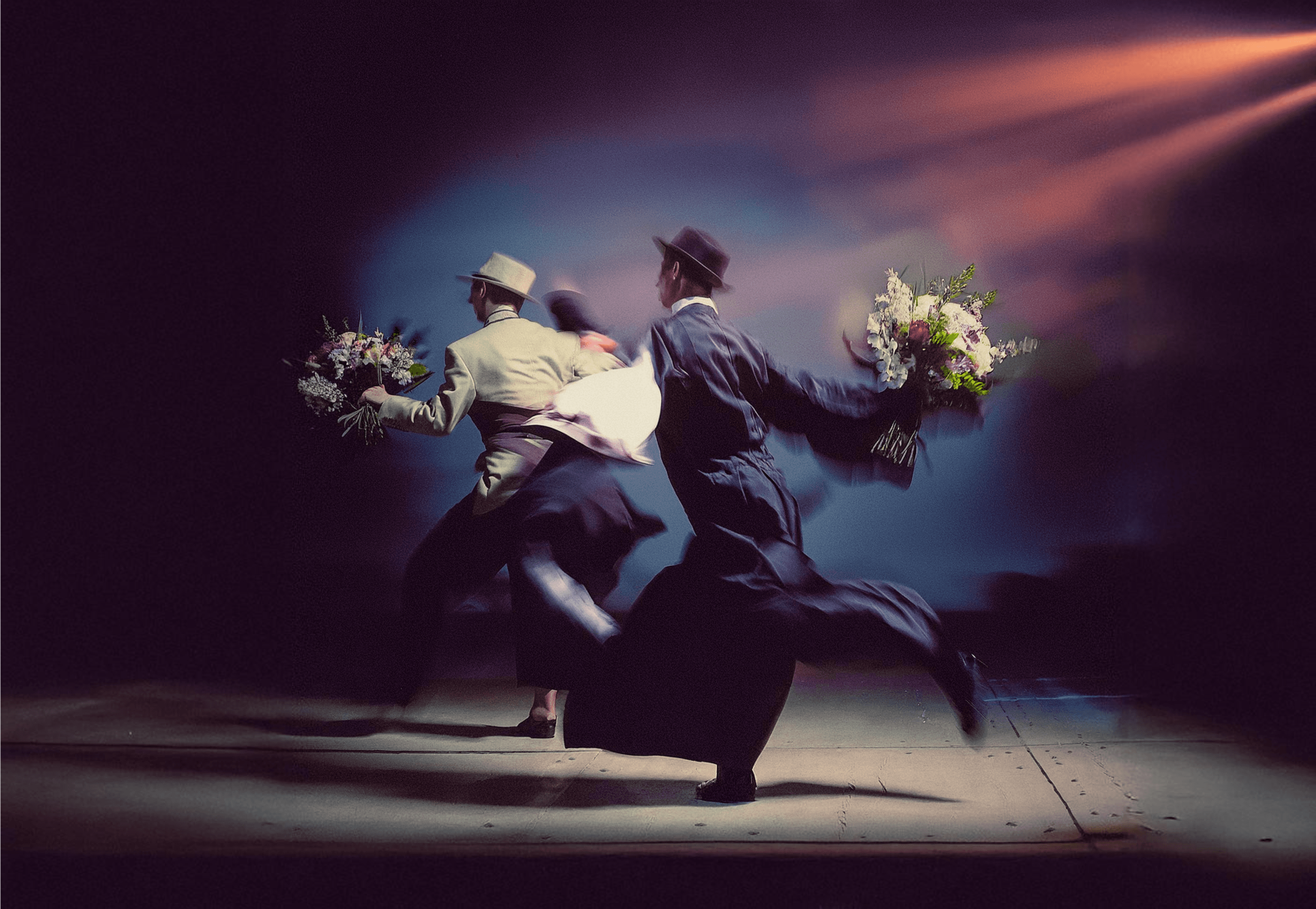 Three people sitting on a couch in a room looking at mobile devices