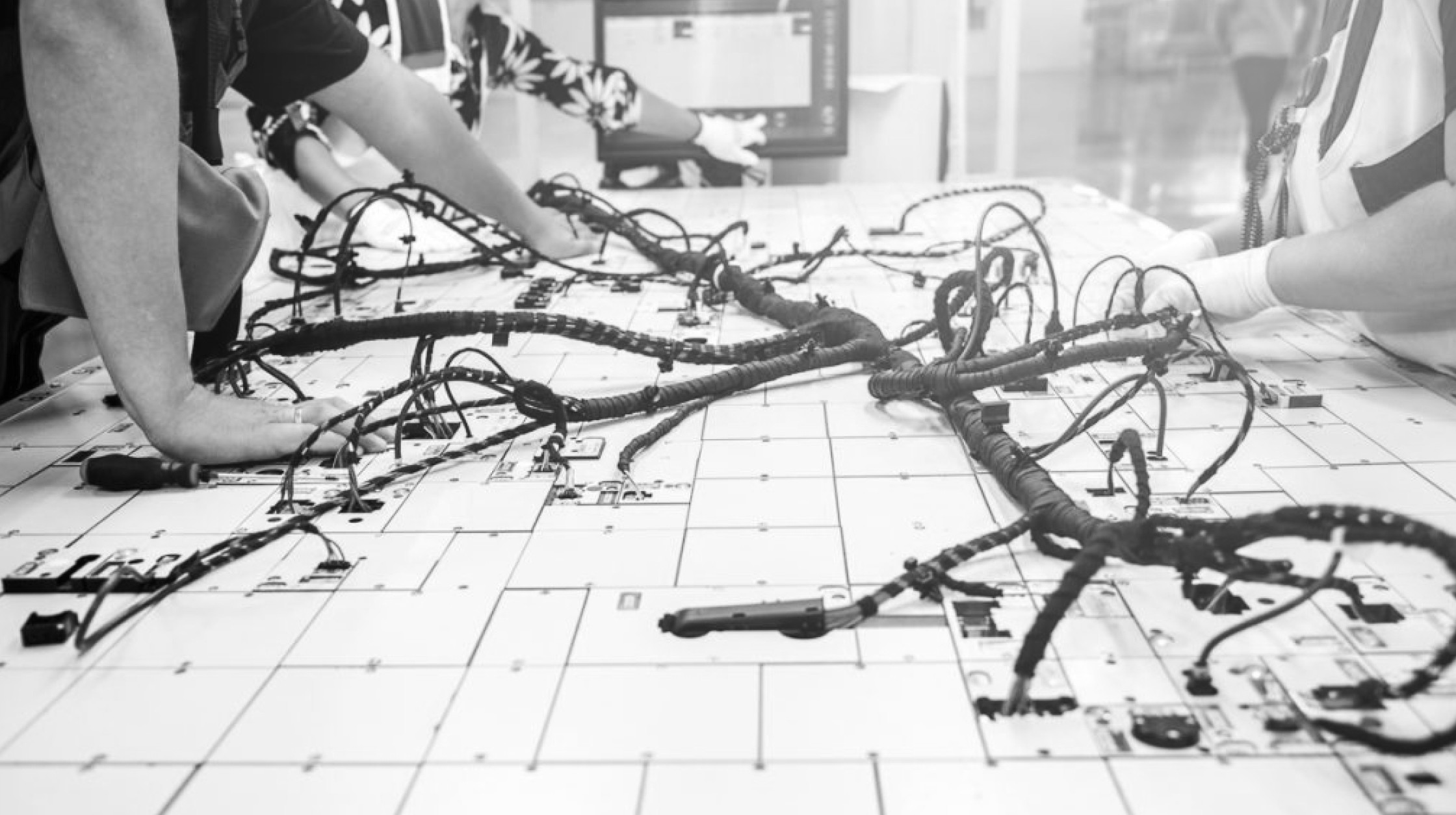 A Photo of Q5D Team working on their project - wires streached across a table