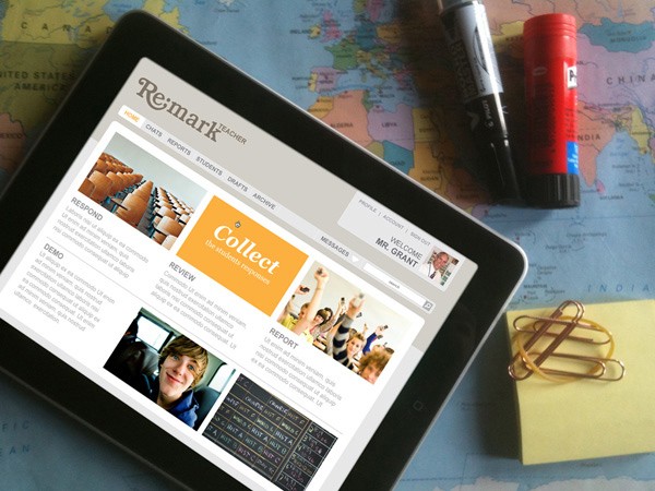 A tablet displaying the Remark Teacher website is open on a table with a world map underneath. The website features sections like "Home," "Collect," "Report," and "Messages." A person's photo is visible in the "Collect" section. To the right of the tablet are a red stapler, a black marker, and a yellow sticky note with paperclips.