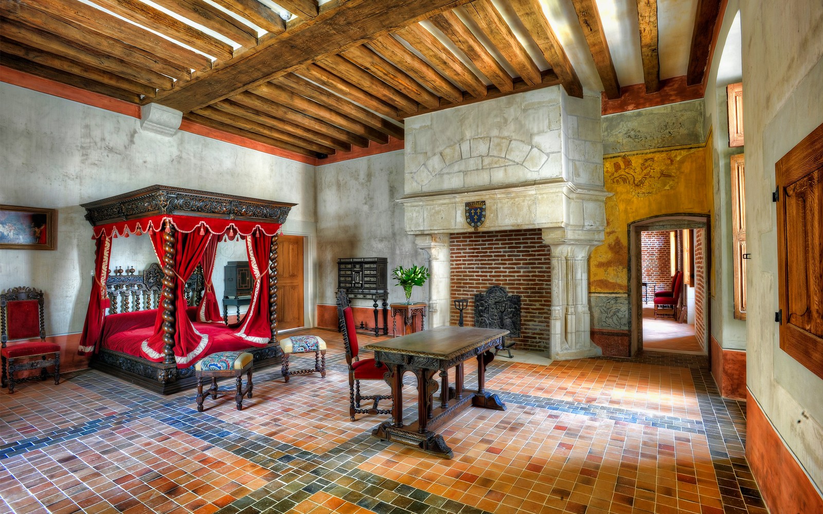 Interior of a historic room with a canopy bed and fireplace at Amboise Castle, France.