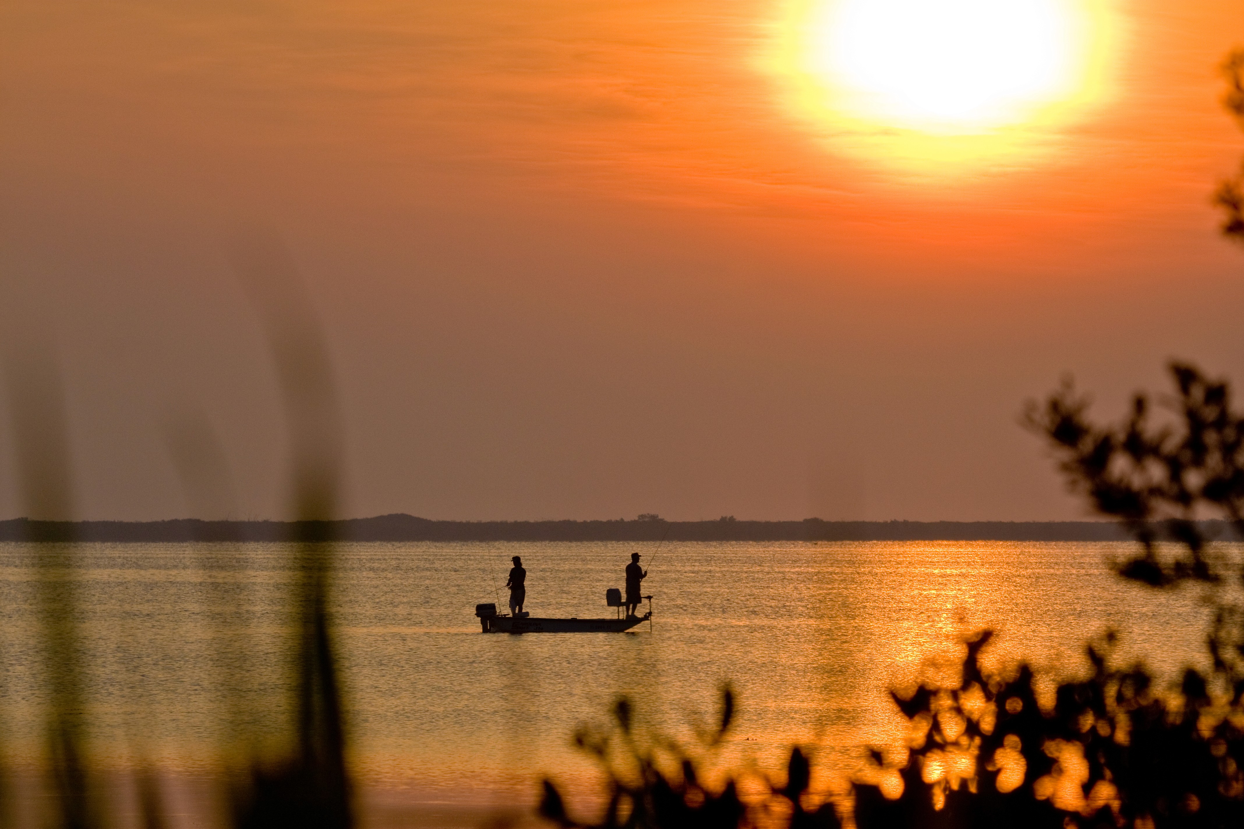  Two people fishing during a sunset at Merritt Island National Park in Florida