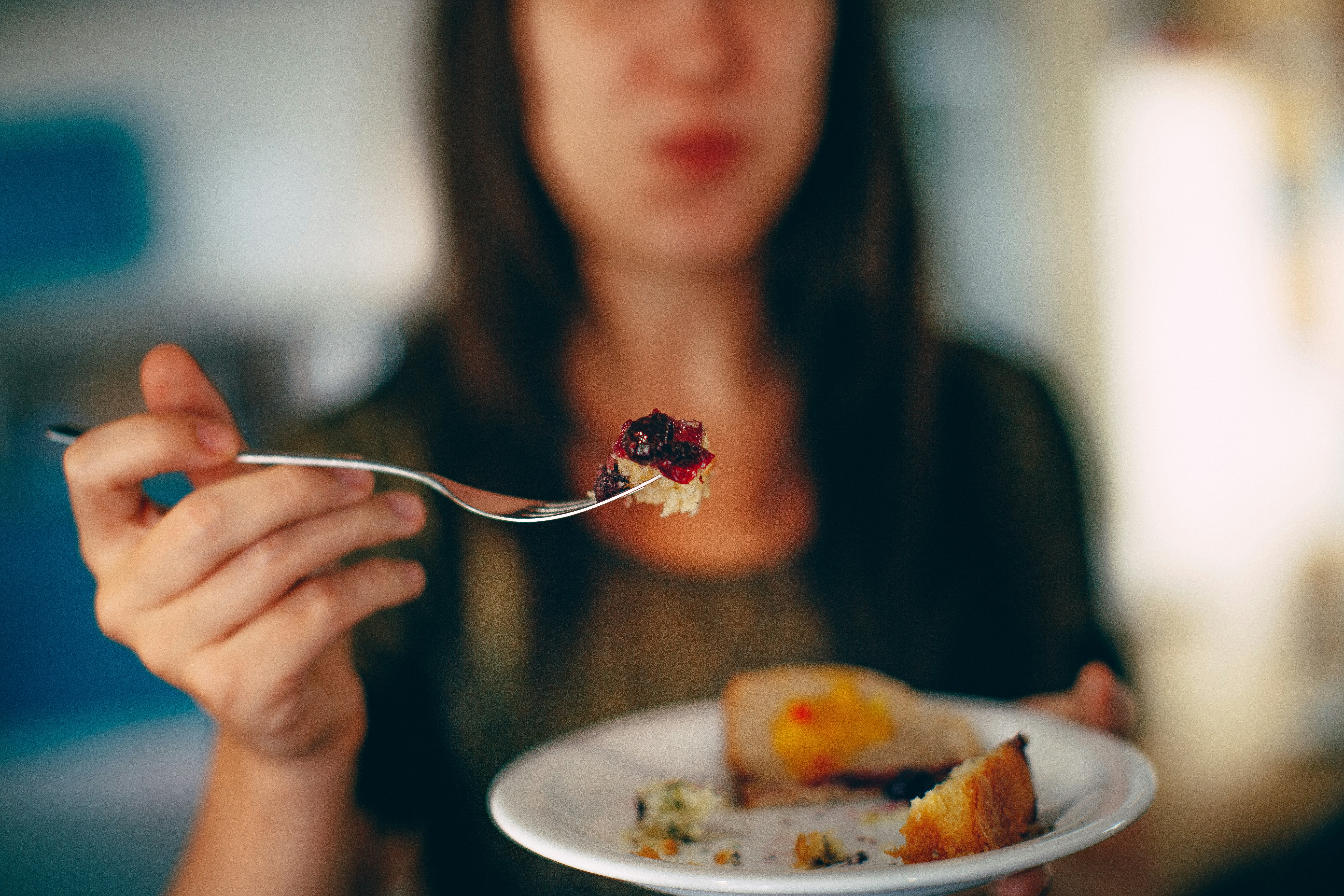 woman holding plate of cake