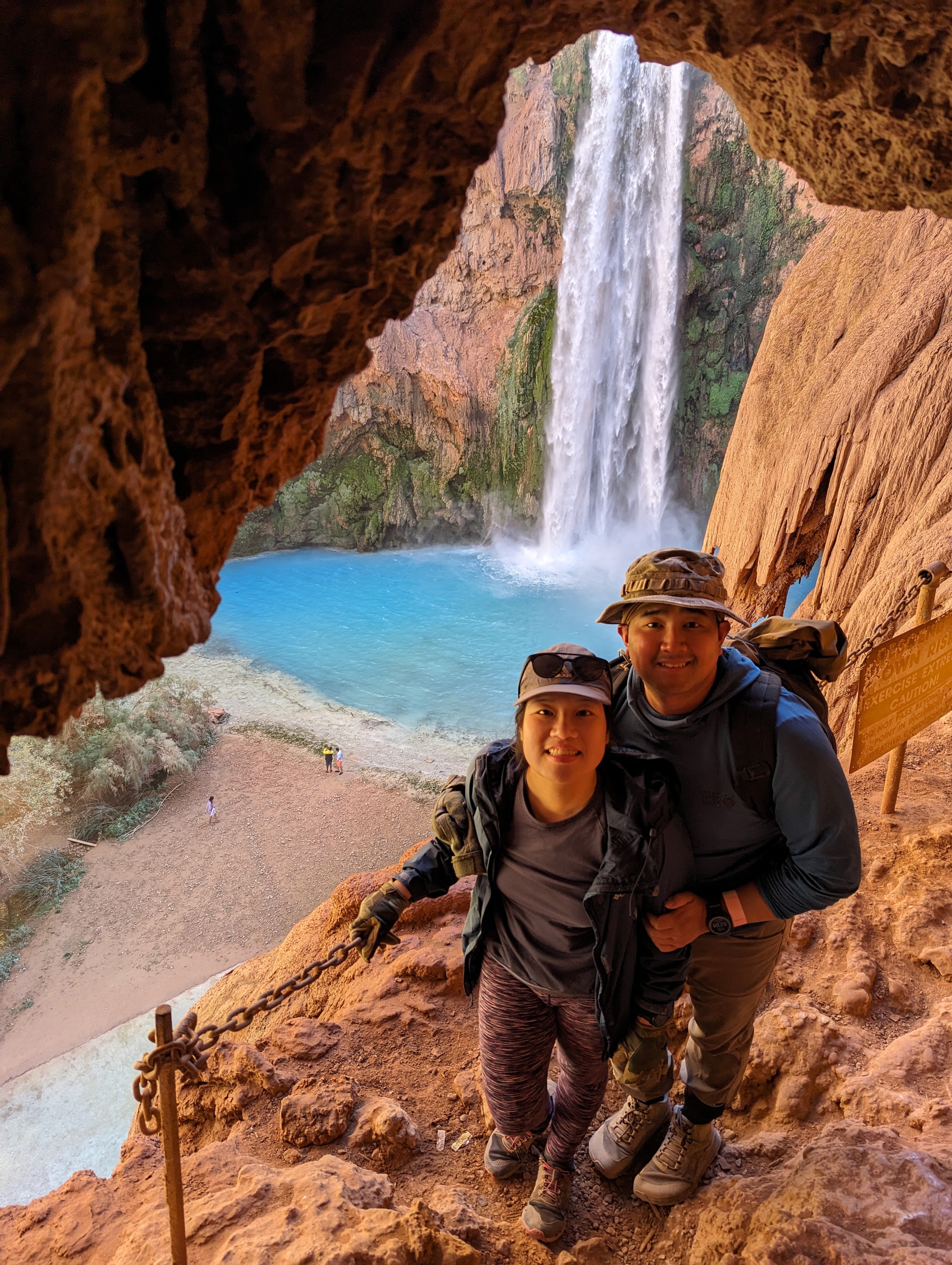 Close-up of two hands gently clasped, one wearing a sparkling engagement ring. The soft lighting and pastel nails evoke a sense of romance and intimacy.